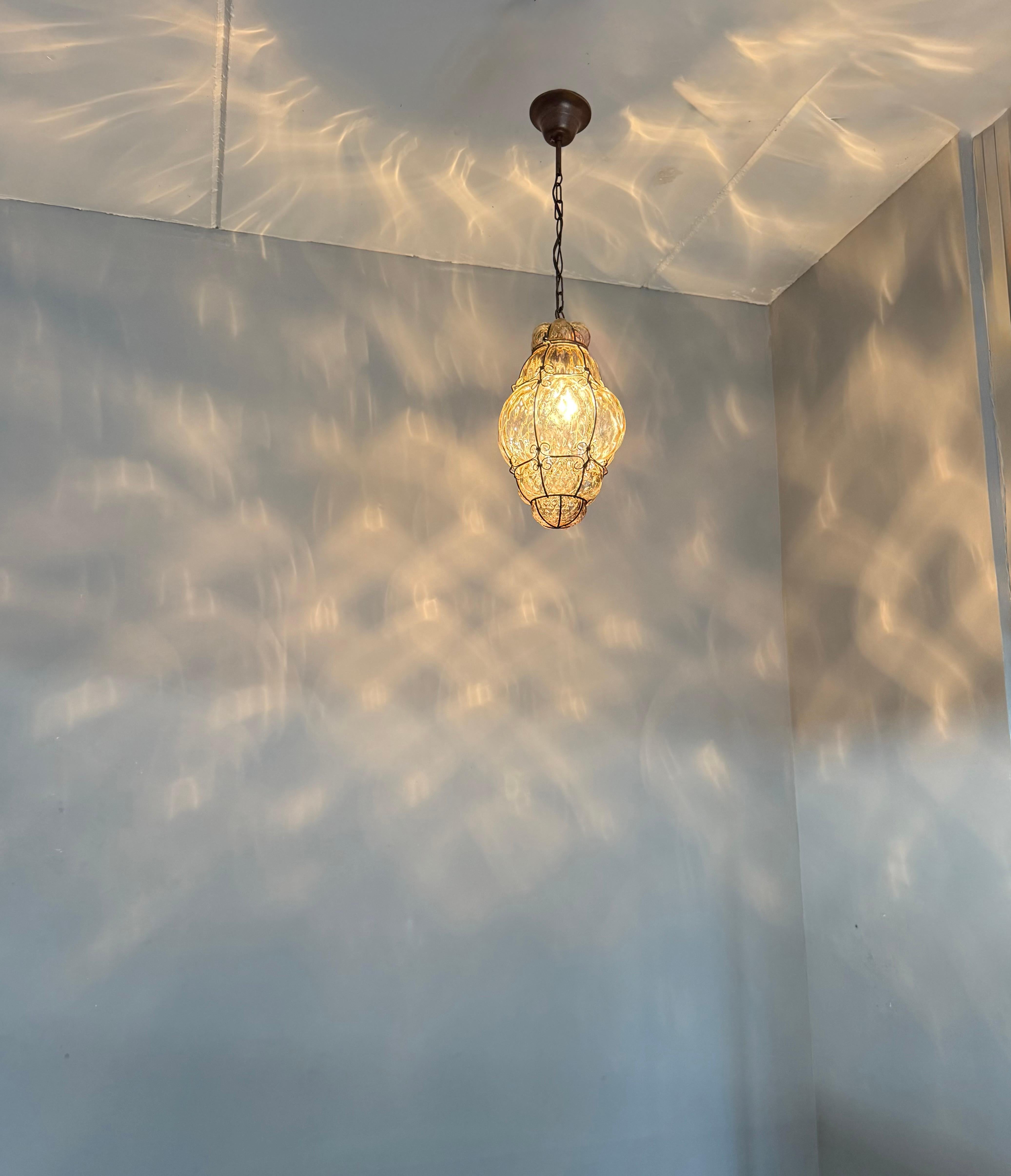 Cast Arts & Crafts Era Venetian Pendant Light of Mouthblown Glass into an Iron Frame For Sale