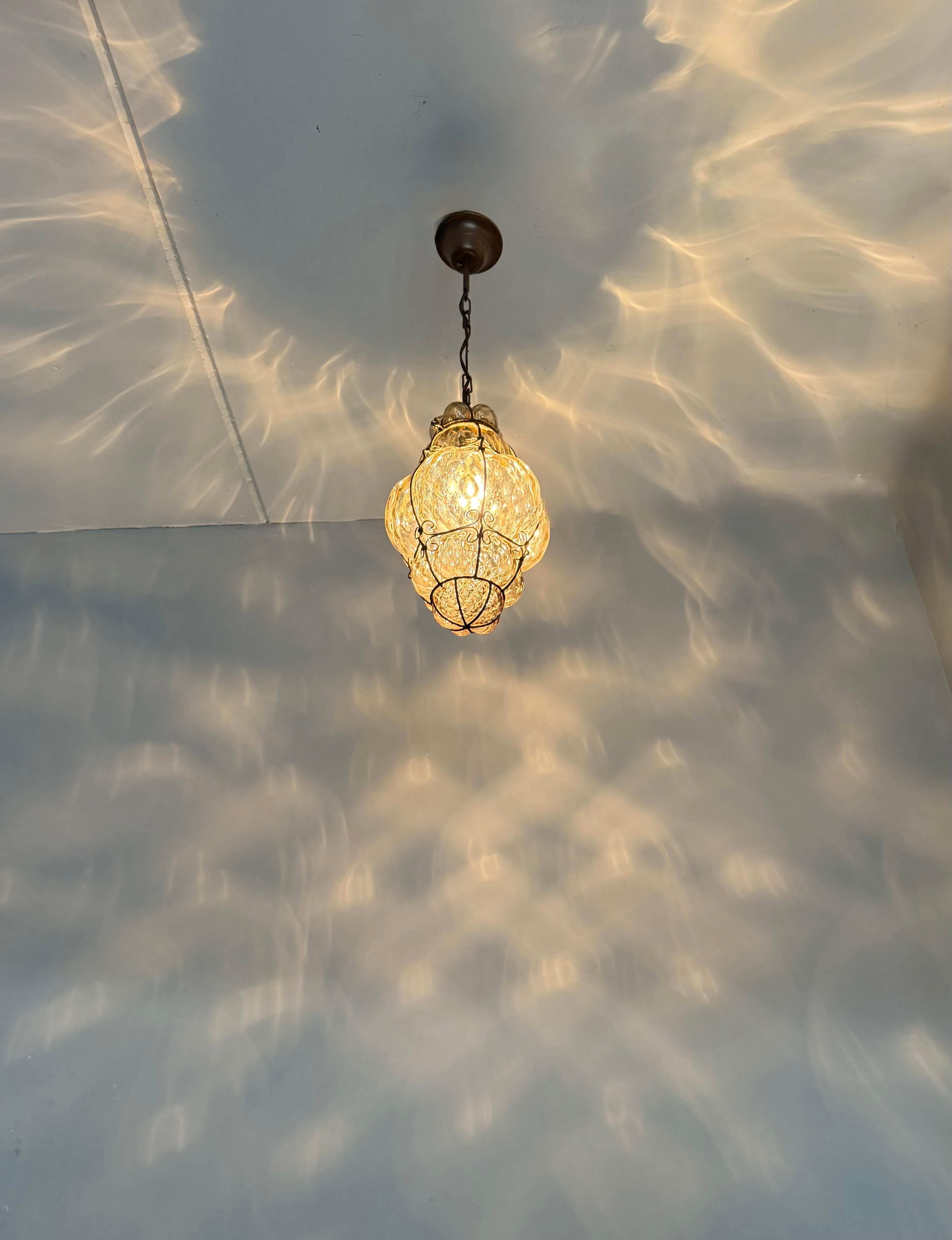 Arts & Crafts Era Venetian Pendant Light of Mouthblown Glass into an Iron Frame For Sale 1