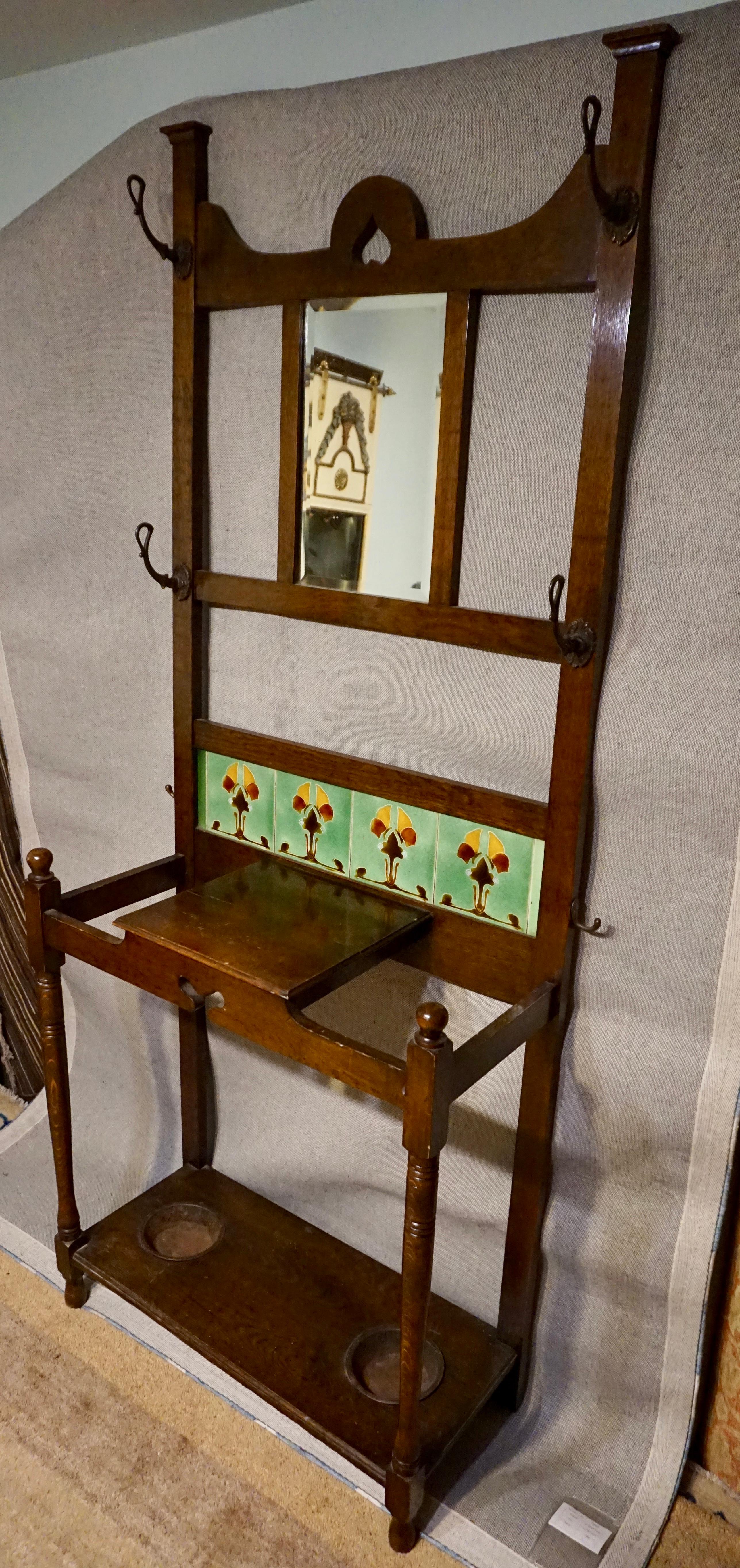 Rare Arts & Crafts versatile coat rack/umbrella stand with drip pans and tabletop. Elegant proportions and subtle detailing of the period make it stand out. Original hardware. Quarter sawn oak construction,

circa 1905-1910.