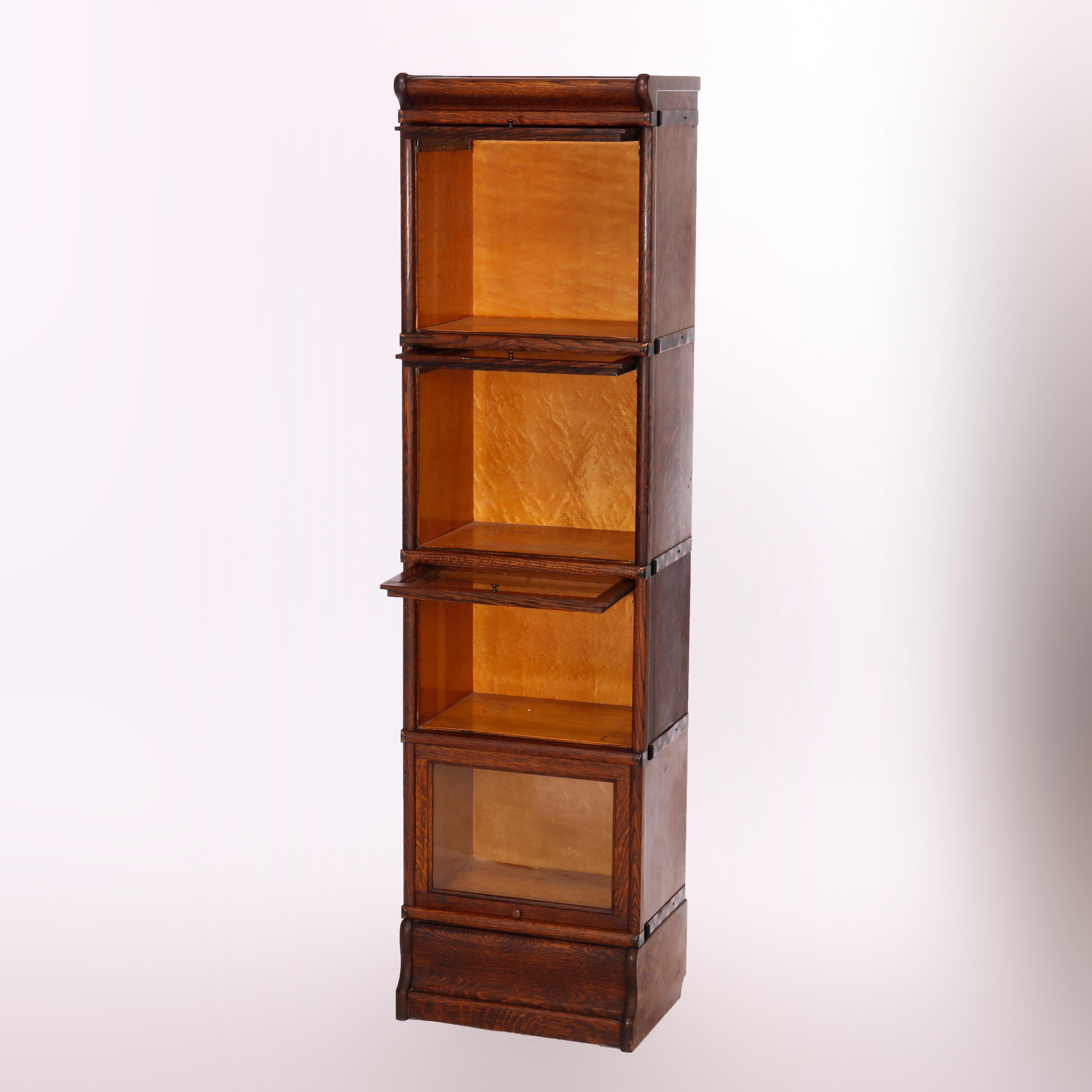 An antique Arts and Crafts Barrister bookcase attributed to Globe Wernicke offers quarter sawn oak construction in diminutive form with four stacks, each having pull out glass doors and seated on ogee base, c1910

Measures - 63.5'' H x 17'' W x