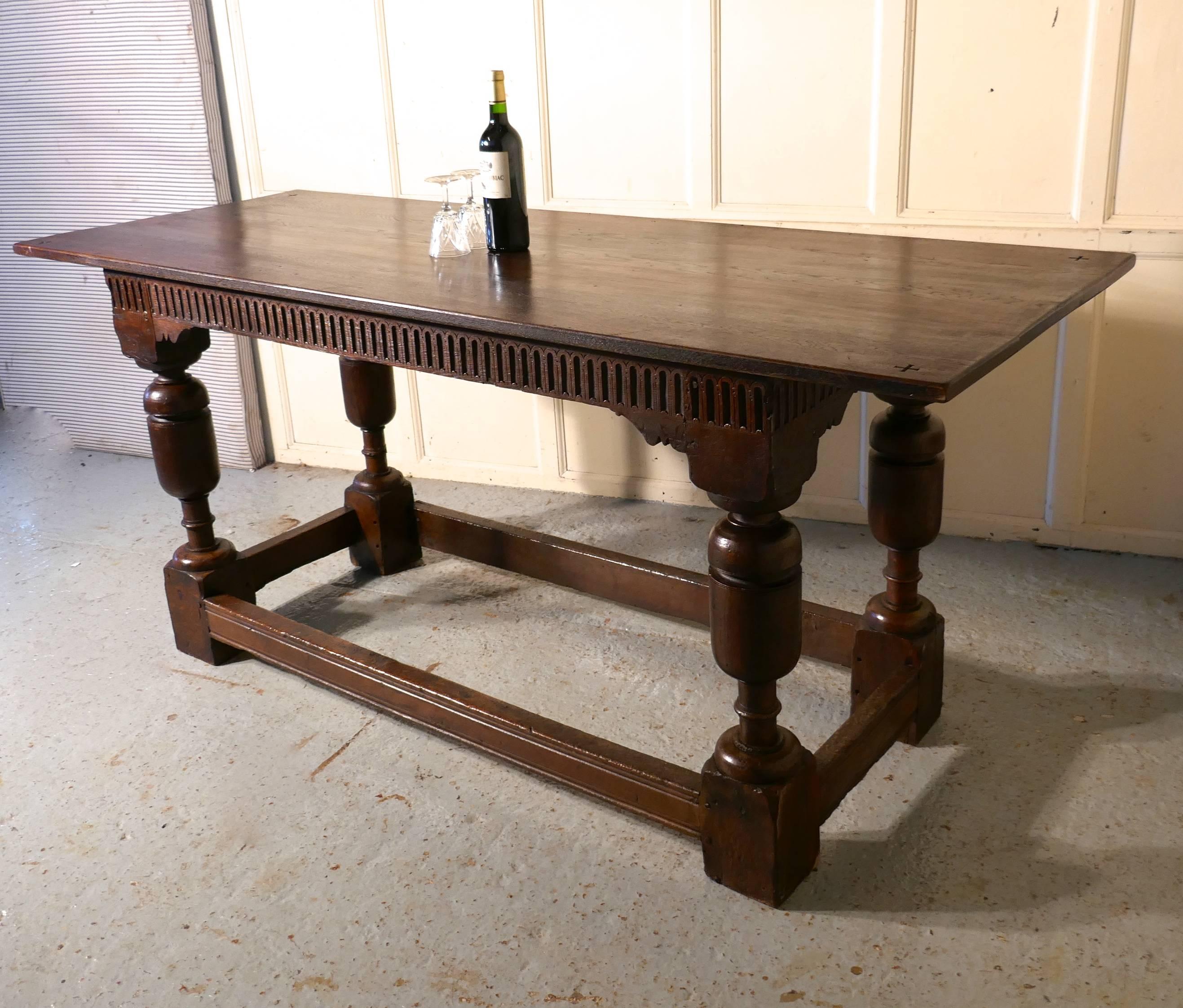 Arts & Crafts Gothic carved oak table 

This is a wonderful table, the table base is an early piece with large bulbous legs, and the apron below has a linen fold carving all the way around. The three plank top dates from the 19th century, it has