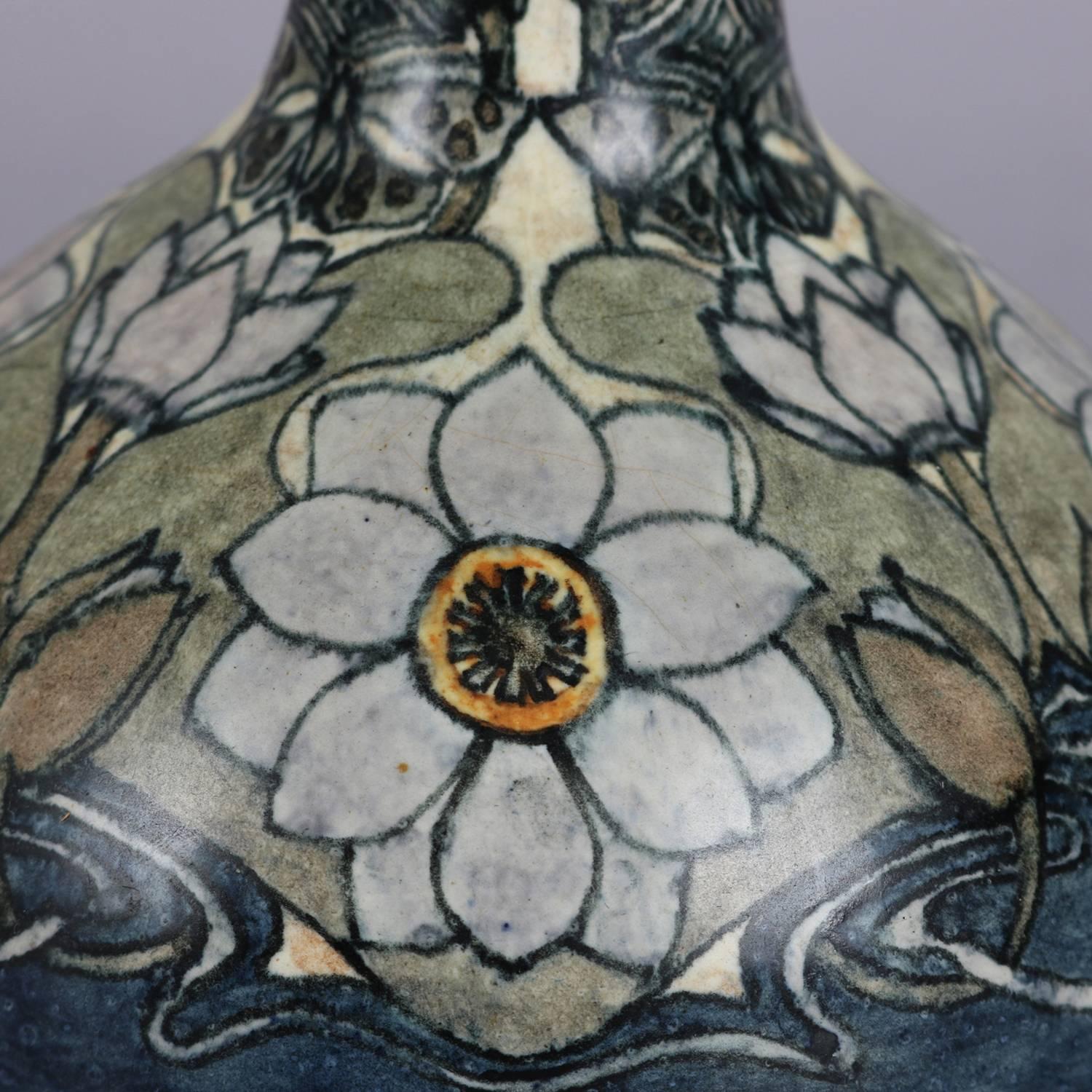 Arts & Crafts Gouda School art pottery bud vase features bulbous base with stylized floral motif, signed Holland Utrecht, circa 1910.

Measures: 12