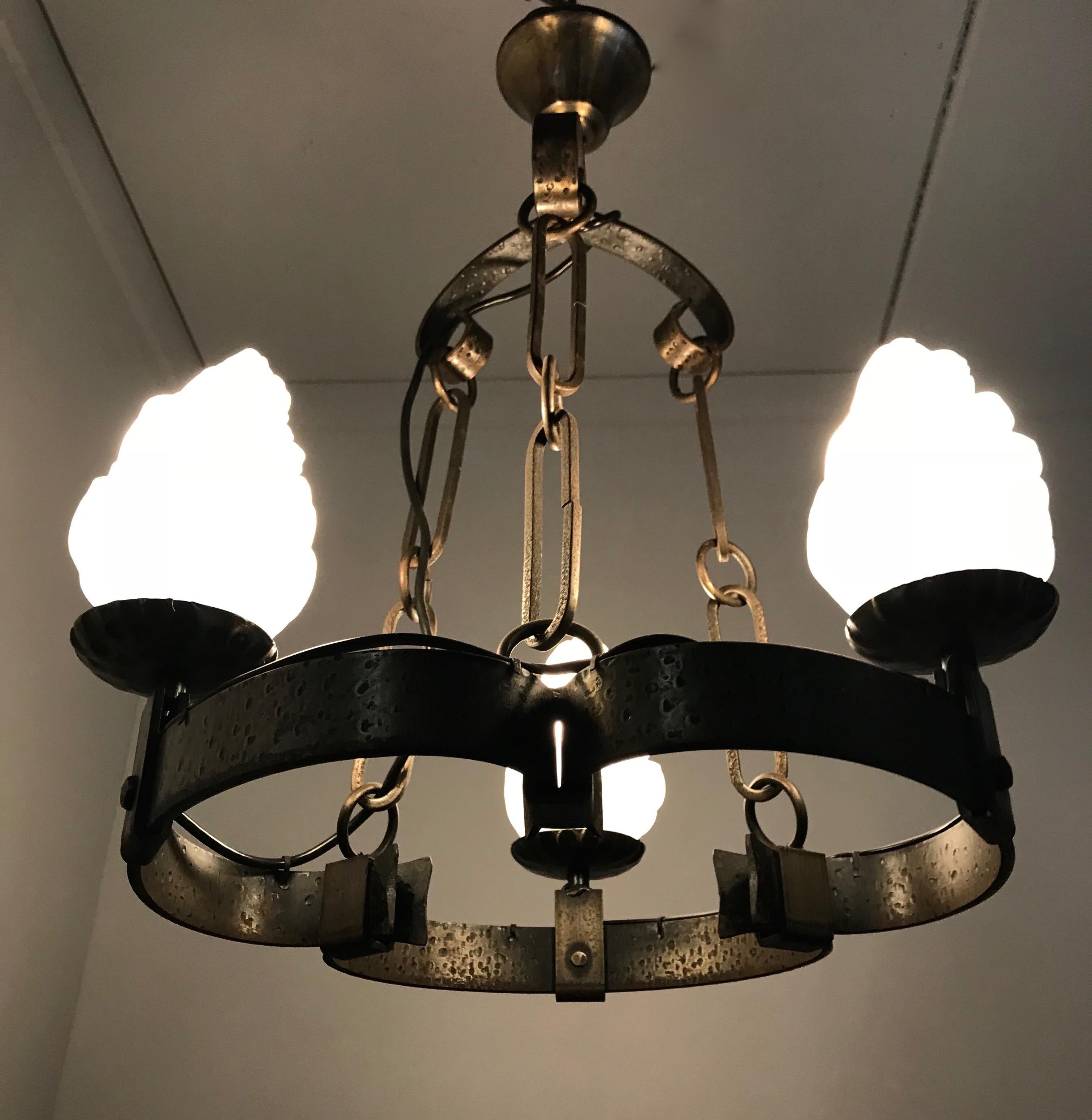 Small size and all handcrafted, castle style chandelier.

This three torch chandelier is practical in size and could be the perfect lighting solution to a space that needs a special atmosphere. The unusual shape when looking at it from the bottom is