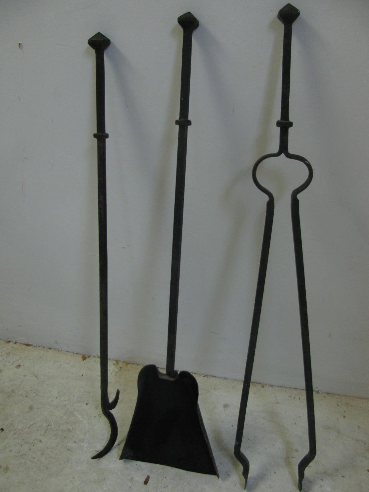 Fine handwrought fireplace tool set. 4 pieces. shovel, poker and a clamp for grabbing the log along with the holder for the tools. All hand forged.