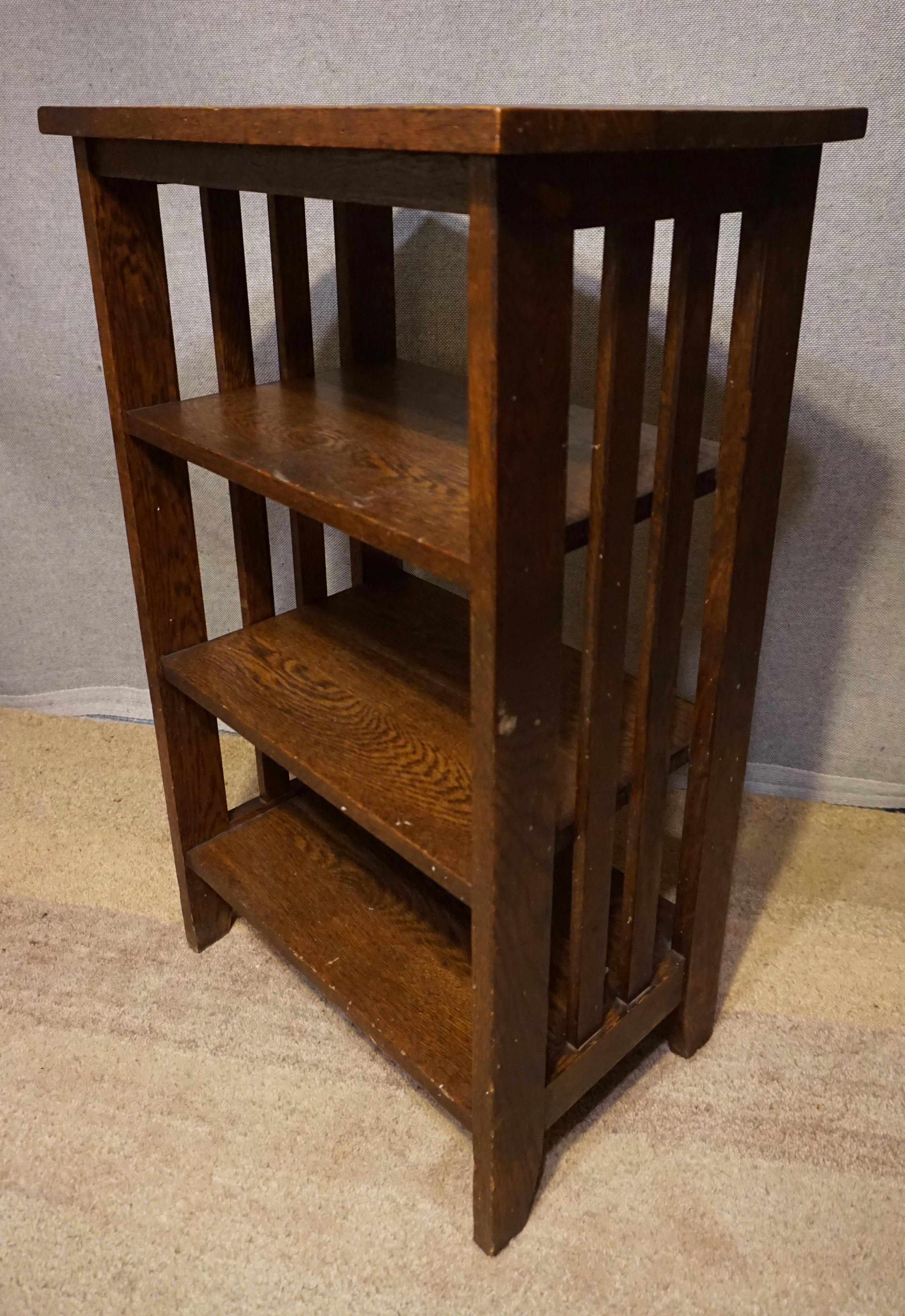Circa 1910

Elegant and compact Arts & Crafts 3 tiered bookshelf with subtle workmanship and clean lines in dark, quarter sawn solid oak. Ideal for a small space/nook.
