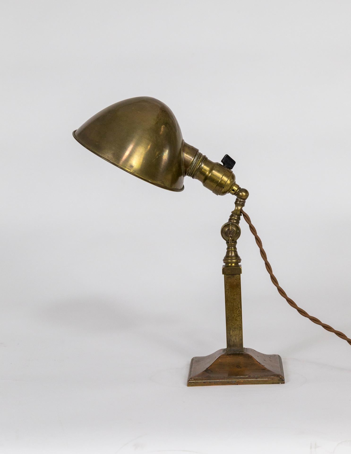 Arts & Crafts style, adjustable Pharmacy desk lamp in patinated brass and copper, with clamshell shade, and square pyramid base. A lovely work of turn of the 20th century Hubbell craftsmanship. With a Bryant socket, newly wired with brown,