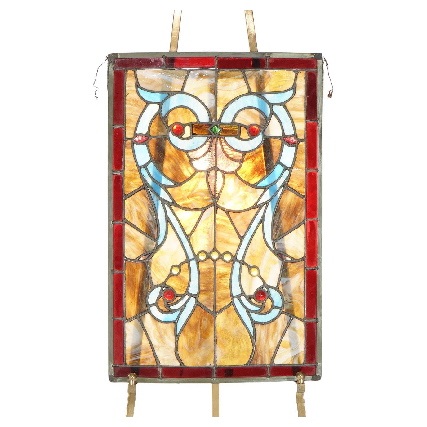 Vitrail Arts & Crafts en plomb, scories et pierres précieuses avec hibou stylisé c1920

Dimensions - 29 1/4 