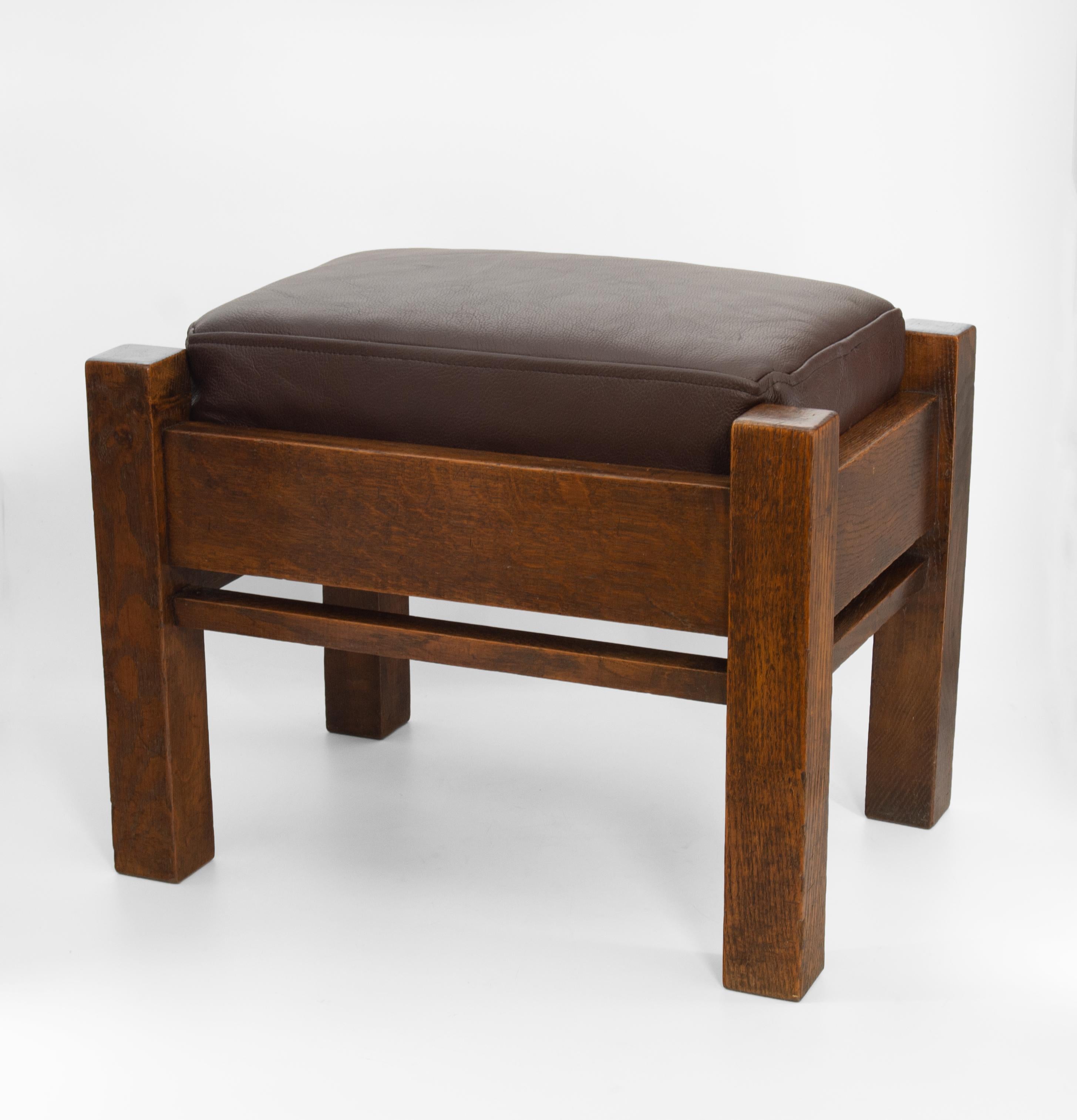 Arts & Crafts oak & leather Mission style footstool by Liberty & Co. The base applied with retailer's plaque 'Liberty Birmingham London & Paris'. Circa 1900.

Delivery included to the mainland UK.
 
The seat pad has a new inner and has been