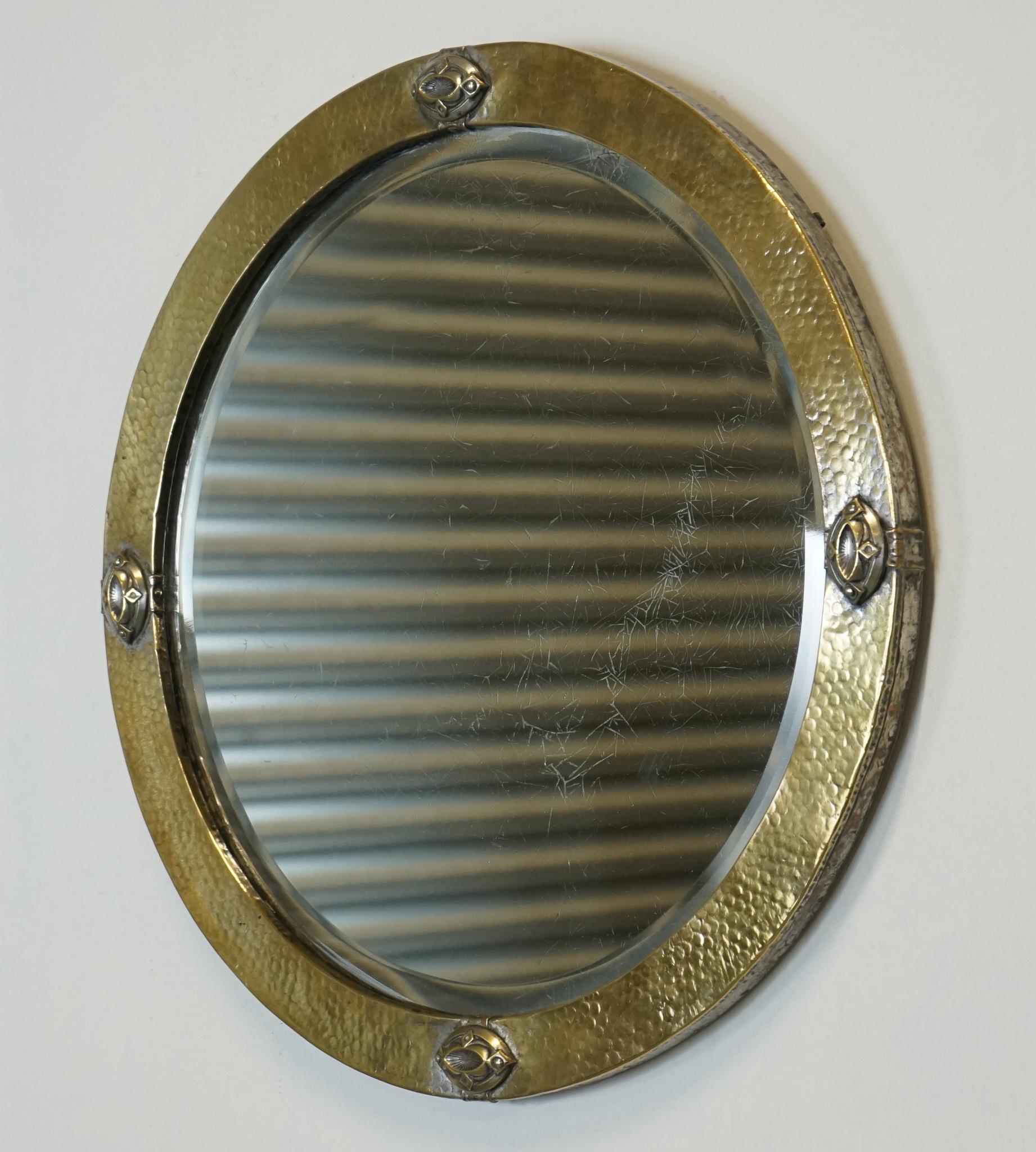 

We are delighted to offer for sale this Arts & Crafts Liberty's London Hammered Brass Mirror Circa 1910's

The Arts & Crafts Liberty's of London Hammered Brass Wall Mirror circa 1910 is a stunning example of the iconic Arts & Crafts movement that