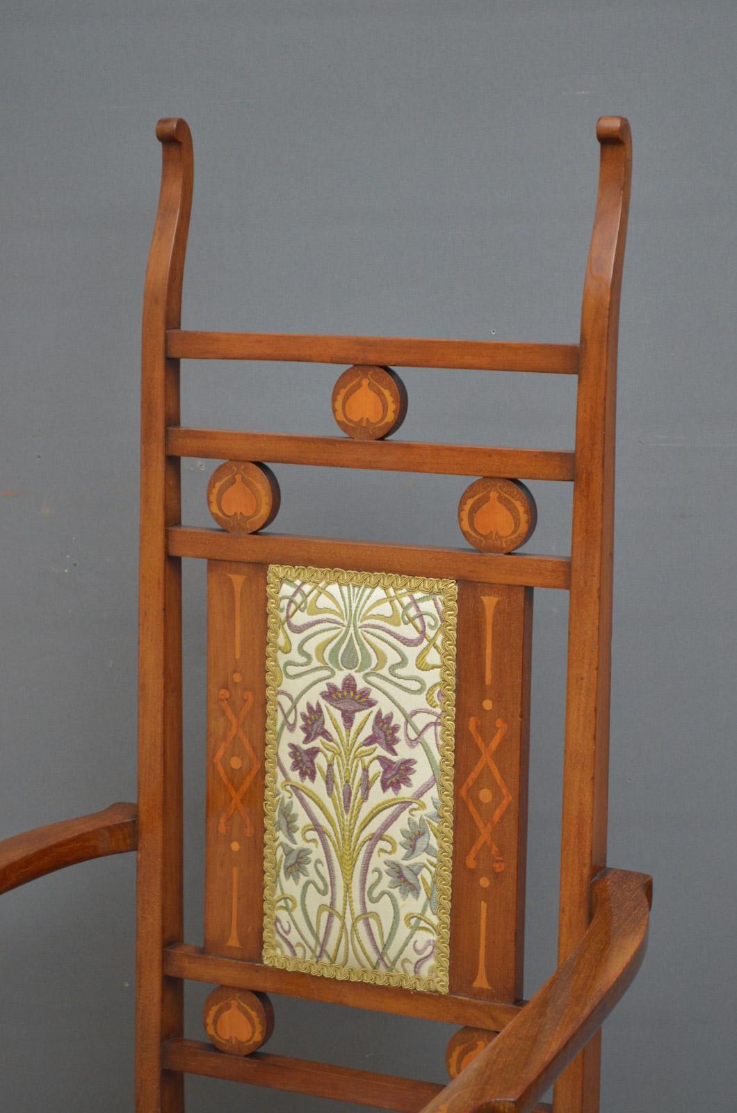 Sn4491 An Arts & Crafts mahogany and marquetry chair by William Lethaby, having shaped and inlaid back, generous seat and open and inlaid arms, standing on square legs and pad feet. This antique chair is in original condition with new top cover,