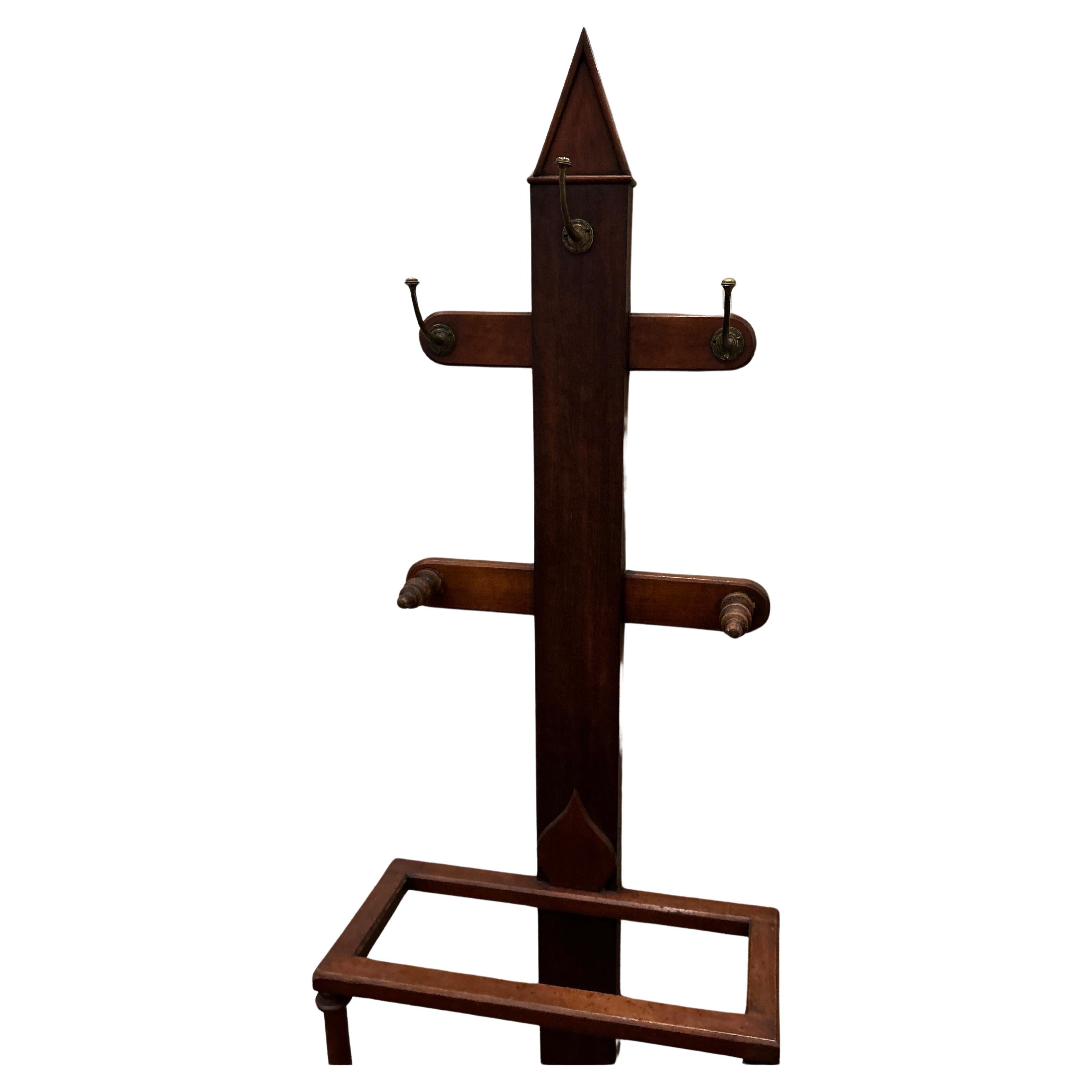 Rare Arts & Crafts Mahogany Hat Stand with original metal drip pan. Hand carved old world craftsmanship exudes finesse. This piece shines with character and has an understated elegance. It is compact, sturdy and practical. Ideal for a foyer needing