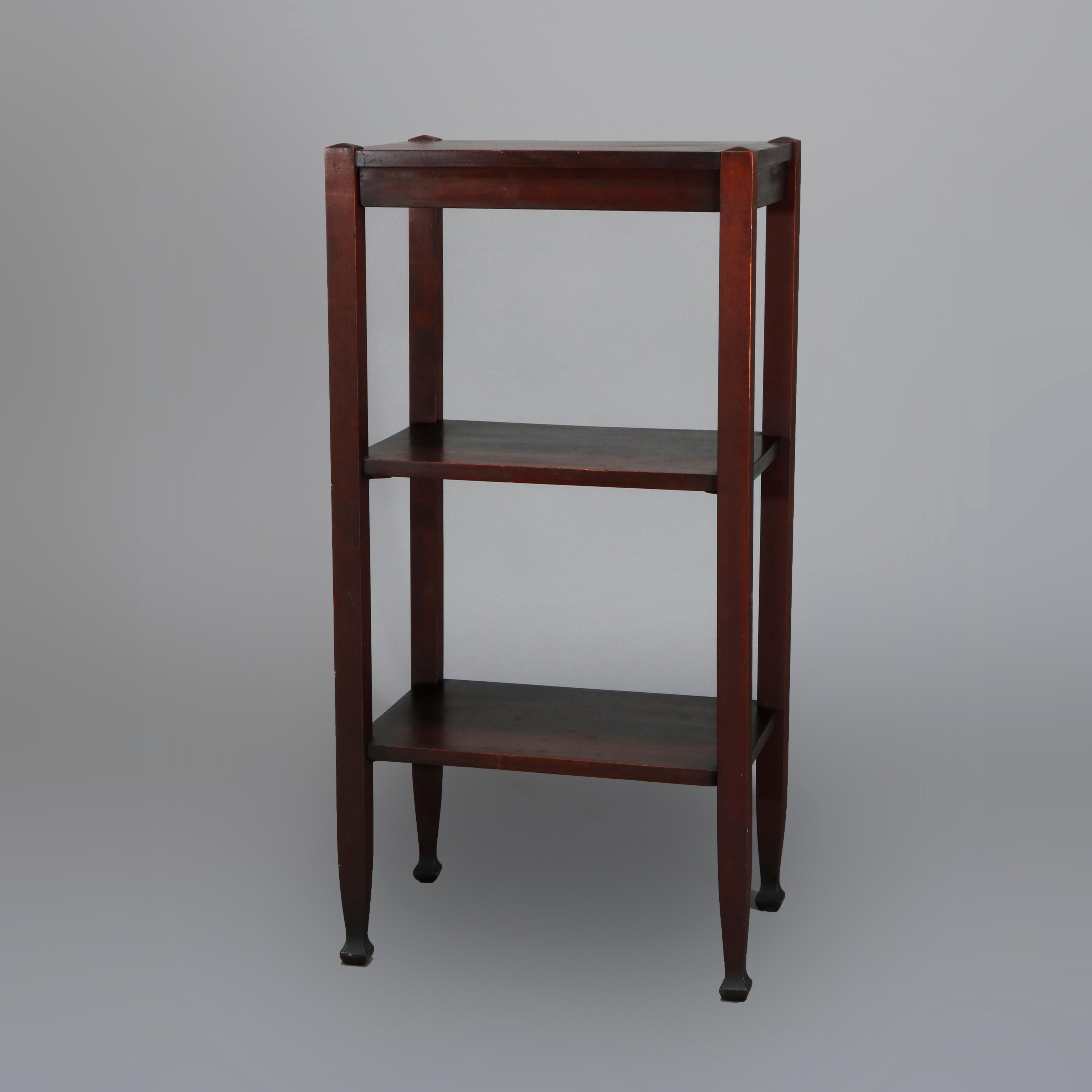 An antique Arts & Crafts pottery display stand by Lakeside Crafters offers upper display over two additional shelves, raised on square and straight legs having McMurdle feet, without label, circa 1910

Measures: 36.25