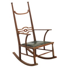 Silla mecedora Arts & Crafts de caoba con asiento de cuero verde, Siglo XX