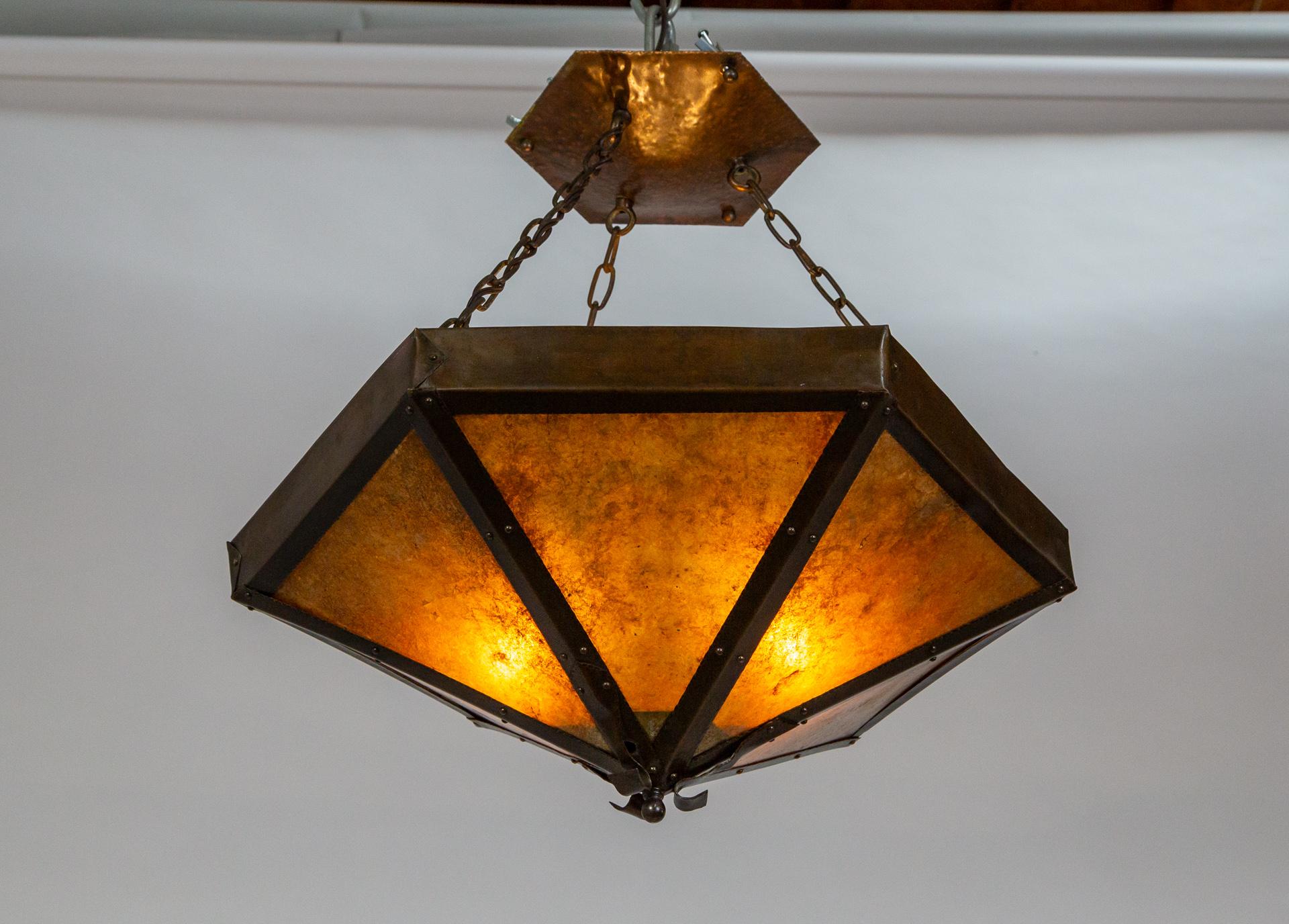 American early 1900s handmade copper and mica 2-light pendant. Charming hand-hammered copper details, rivets and enveloping. Aged mica gives off a pretty glow. Newly rewired and restored.
    