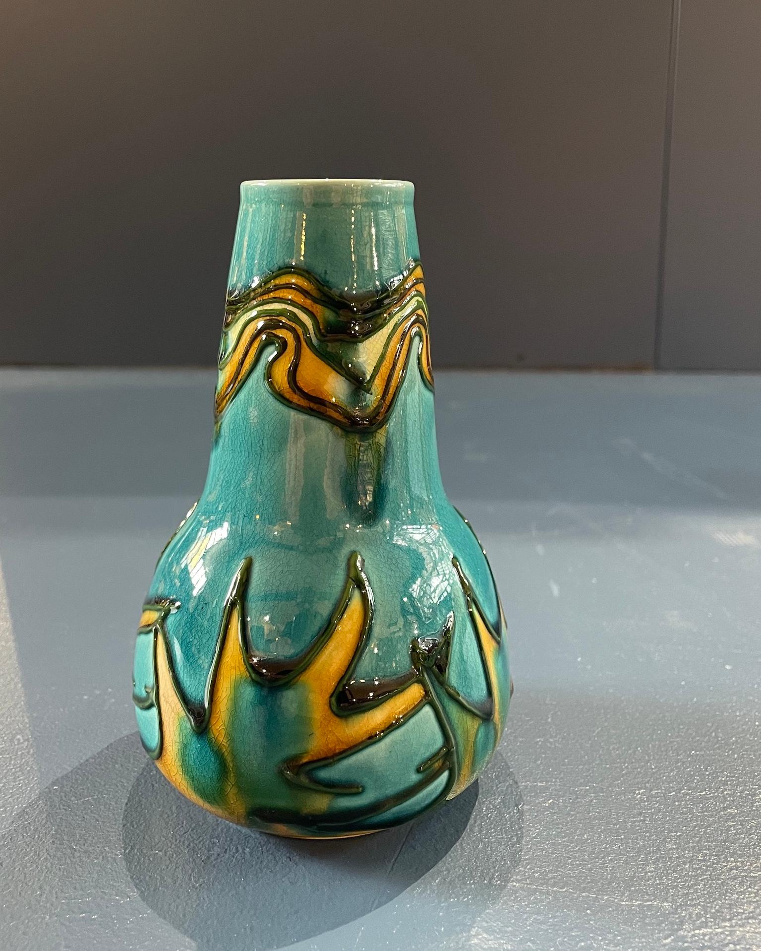 Arts & Crafts tubeline Secessionist Vase

In blues and yellows

Stamped Mintons 3547

Circa 1900 

Height 13.5cm. Diameter 8cm