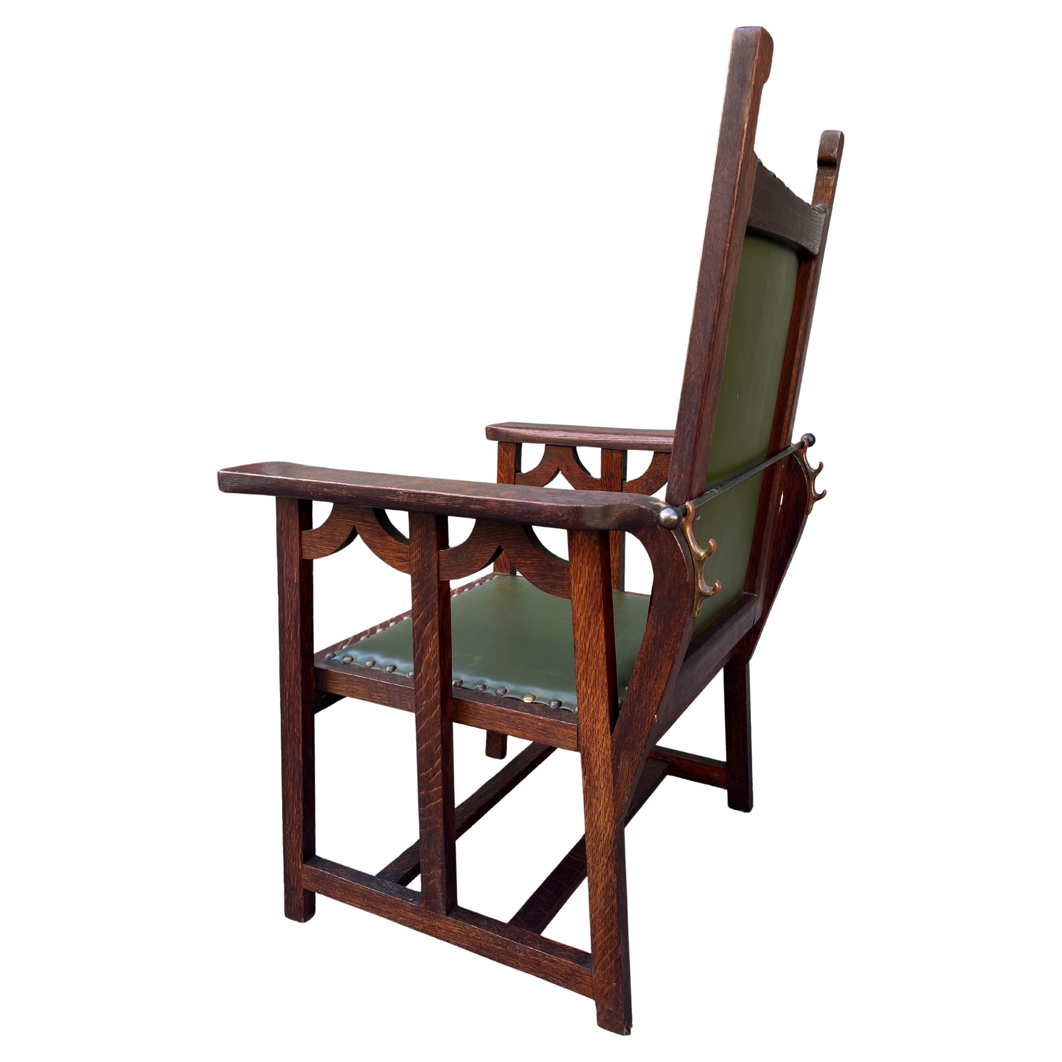 Spectacular Morris chair made of solid oak and original green leather. Has three position reclining positions. Very sturdy and well built. Unique piece with a dash of Spanish Revival. From a big collector in NY. 

Unmarked. 