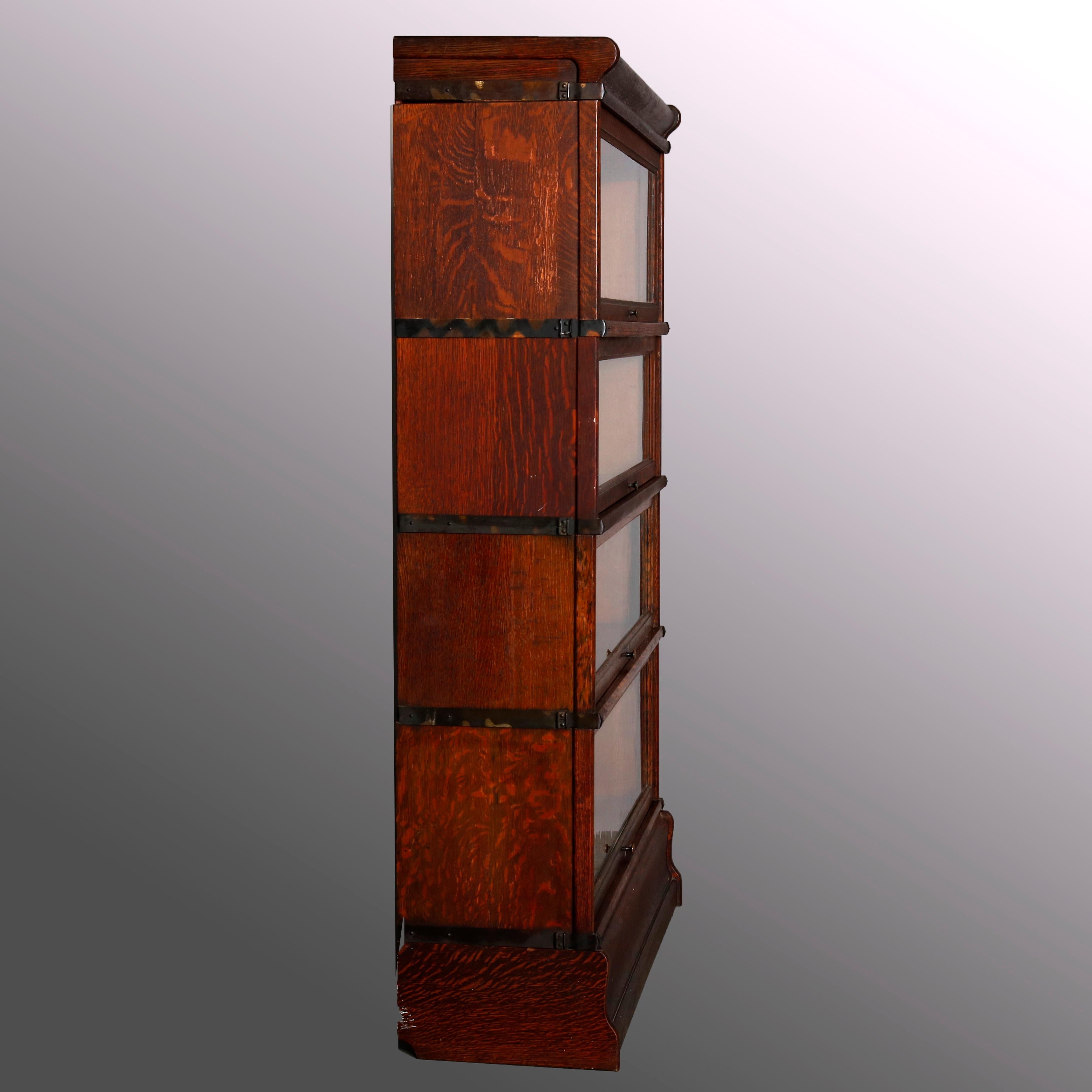 An antique Arts & Crafts mission oak barrister bookcase by Globe Wernicke offers quarter sawn oak construction with four stacks, each having pull-out glass doors and original maker labels, one stack by Mace as photographed, original labels, circa