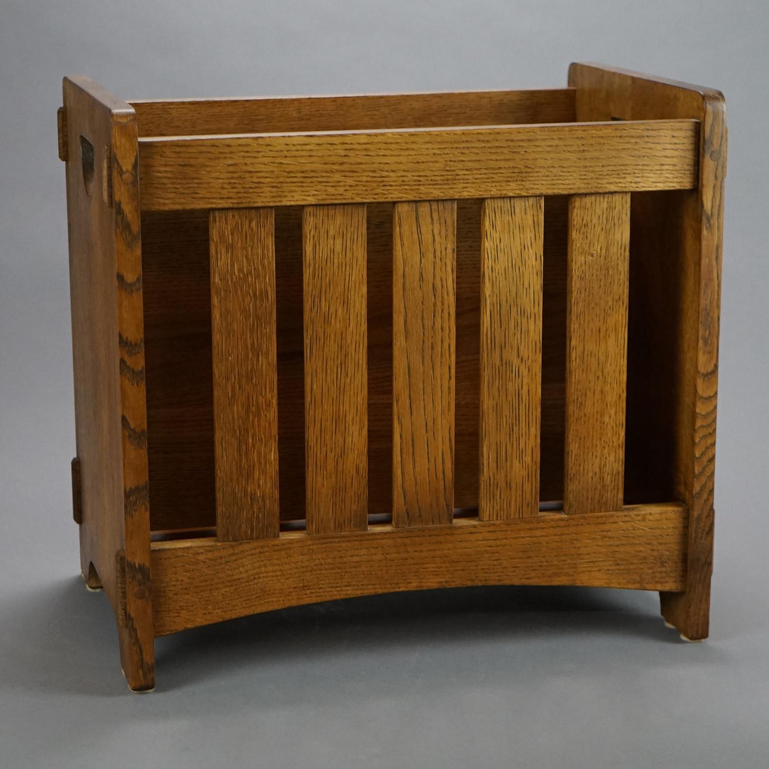 An Arts & Crafts magazine rack by Stickley offers oak construction with slat sides enclosing a divided interior; sides with cutout handles; maker mark as photographed; 20th century

Measures- 17''H x 18.5''W x 12''D.