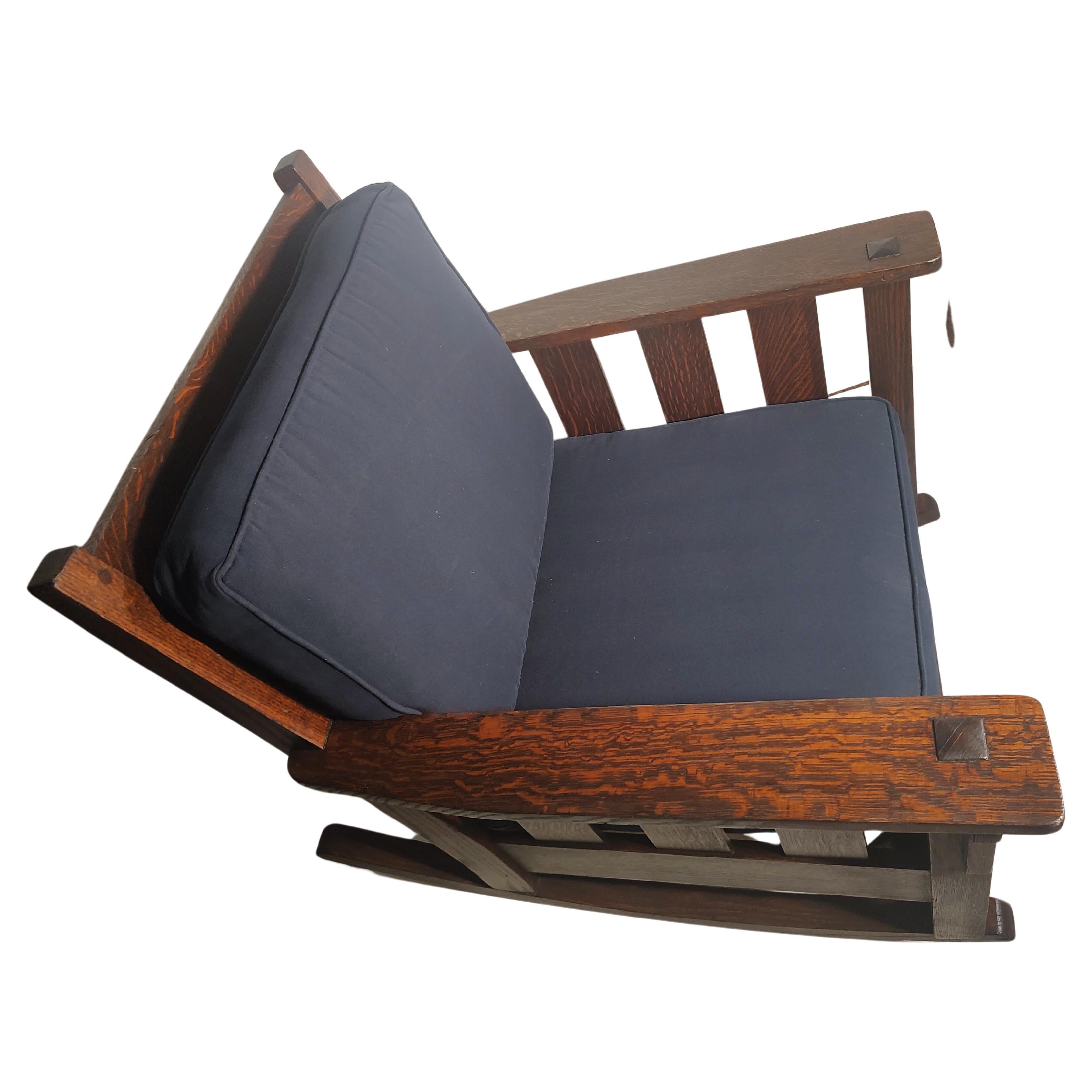 Fabulous heavy duty slatted rocking chair in excellent antique condition attributed to the Stickley Brothers furniture Co. Deep rich color to the quarter sawn oak. All pegged with mortise & tenon construction. Large flat paddle arms with wide slats