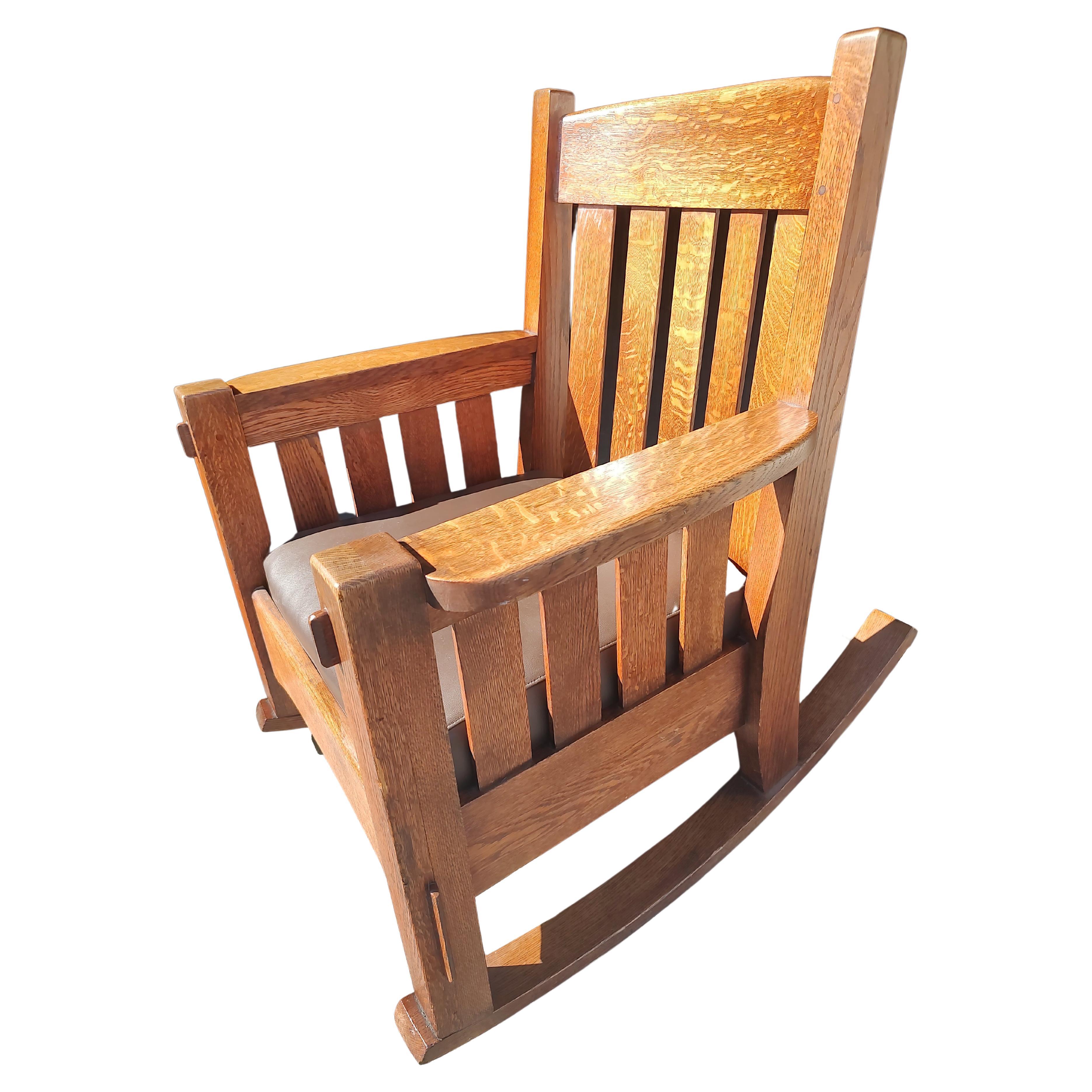 Fantastic heavy duty rocking chair by Harden furniture co. Unsigned but has all the attributes with chunky posts mortise & tenon construction, pegged etc. All quarter sawn oak with a semi new leather seat . No issues to speak of. In excellent