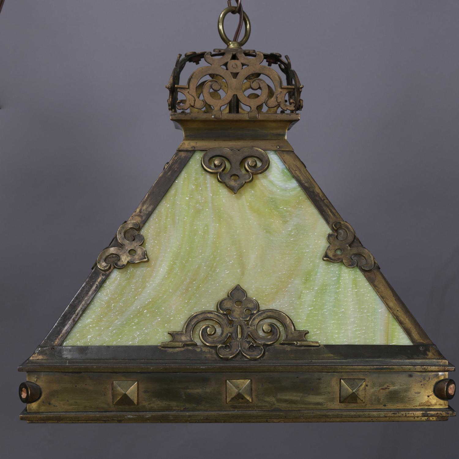 An Arts & Crafts Mission style chandelier features dome shade with cast frame having scroll decoration, single socket and housing four slag glass panels, circa 1910.

Measures: 27