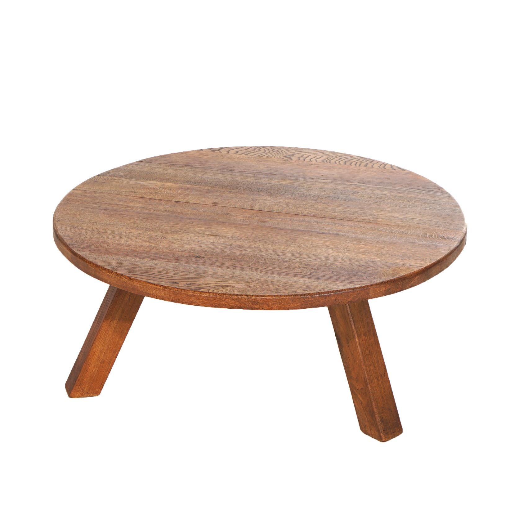 An Arts and Crafts Mission style low table offers oak construction with round top over splayed square legs, 20th century

Measures - 17.25h x 39.5