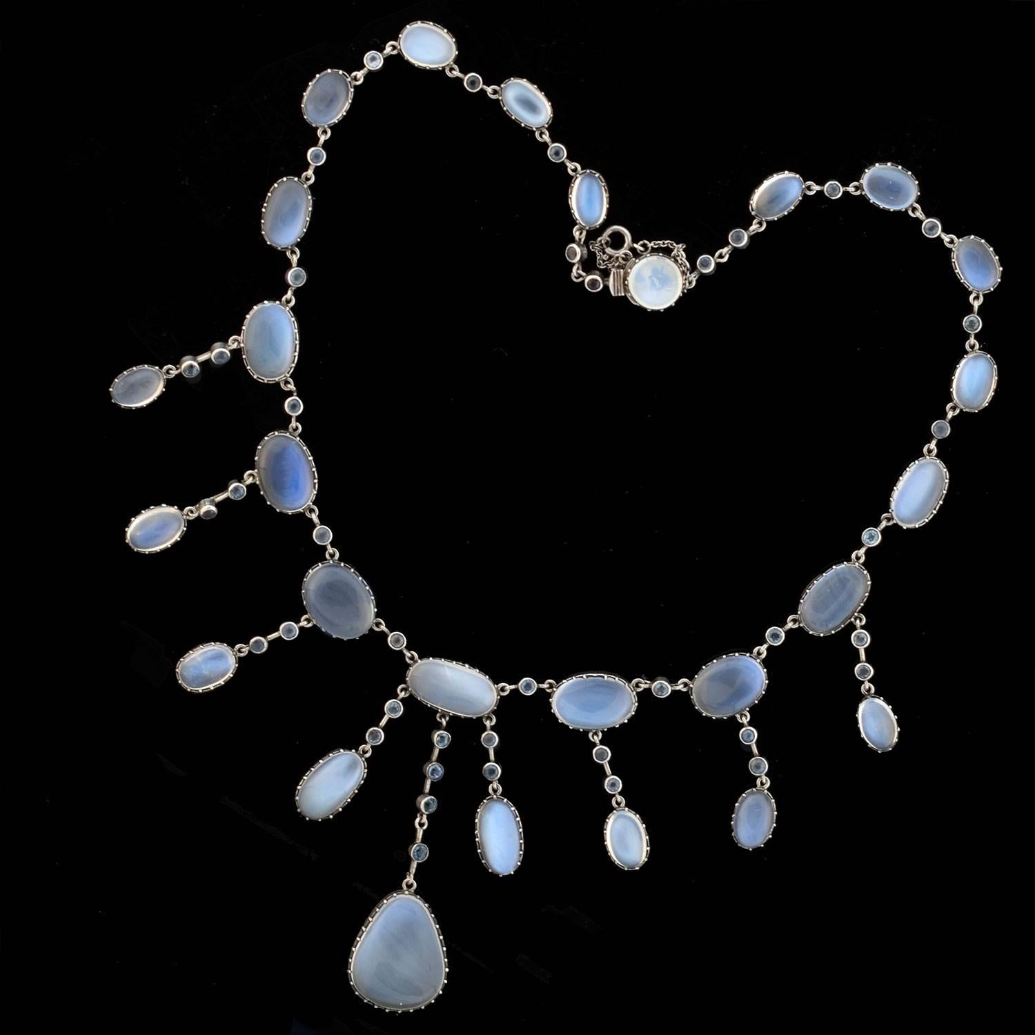 A dramatic festoon moonstone necklace from the Arts & Crafts era (ca1910)! This incredible piece is crafted in sterling silver and comprised of stunning moonstone and aquamarine links that form an elegant festoon necklace. The necklace displays a