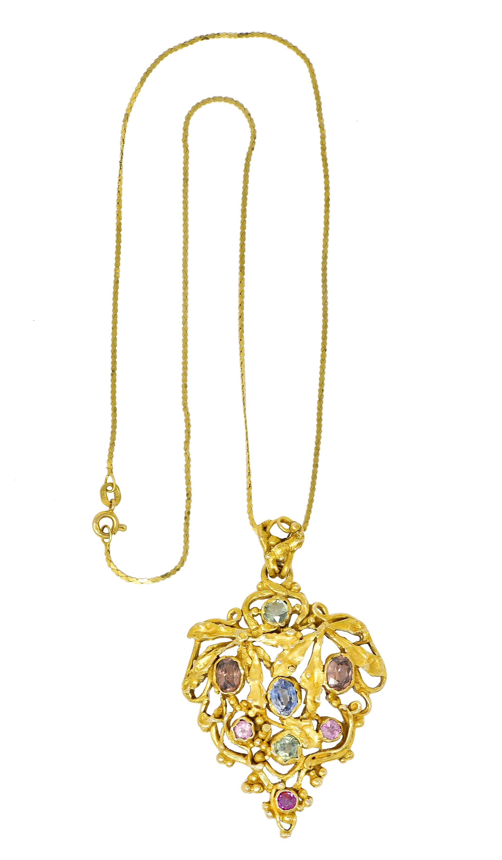 Necklace centers substantial pendant designed as a stylized cluster of grapes with textured leaves and gold bead accents

Round cut and oval cut gemstones are bezel set as grapes - sapphire, tourmaline, and zircon

With an ornate bale and