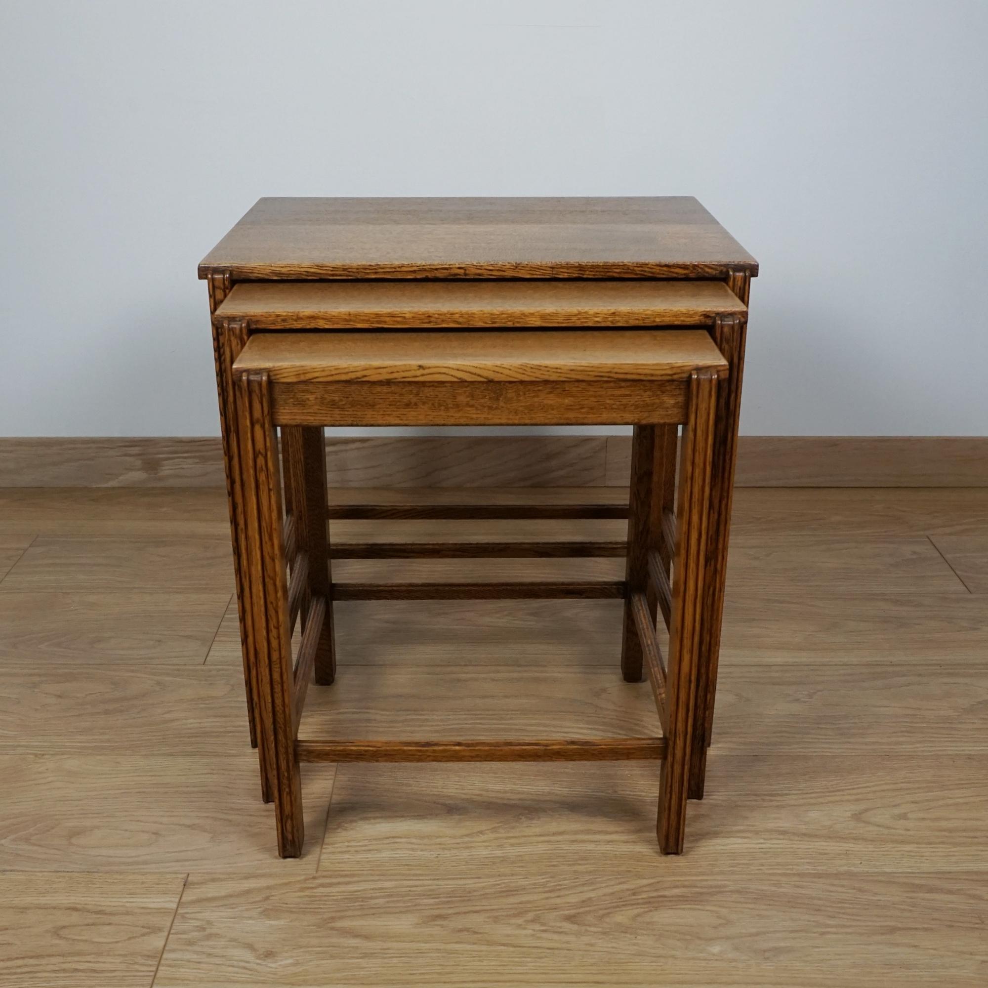 An Arts & Crafts Early 20th Century nest of three tables. Solid Oak. Label to underside. 


