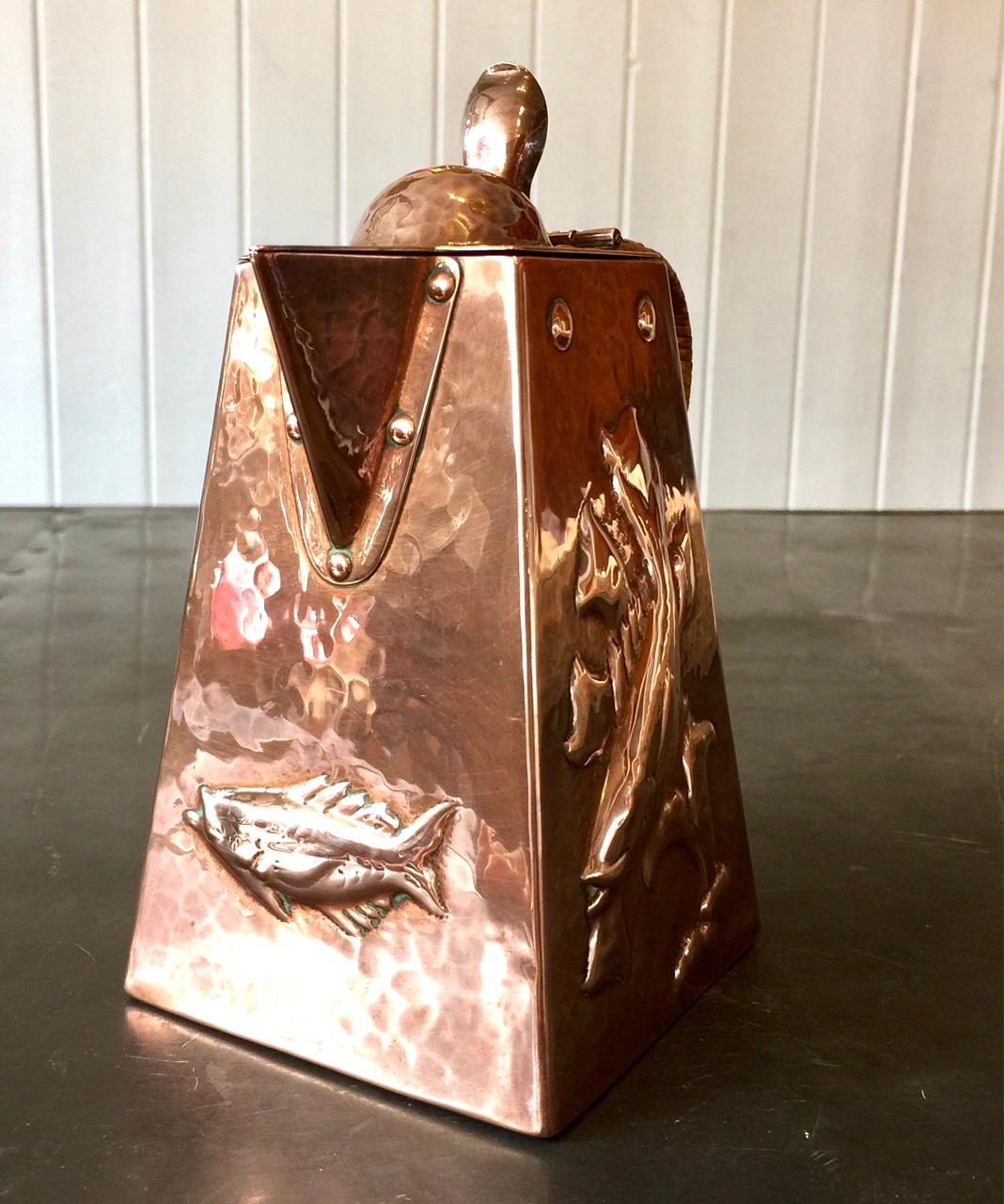 This exquisite Newlyn copper water jug is typical of the work produced by various artists working in the Arts & Crafts movement in the Cornish fishing village of Newlyn in the late 19th century to early 20th century. Of outward tapered form with