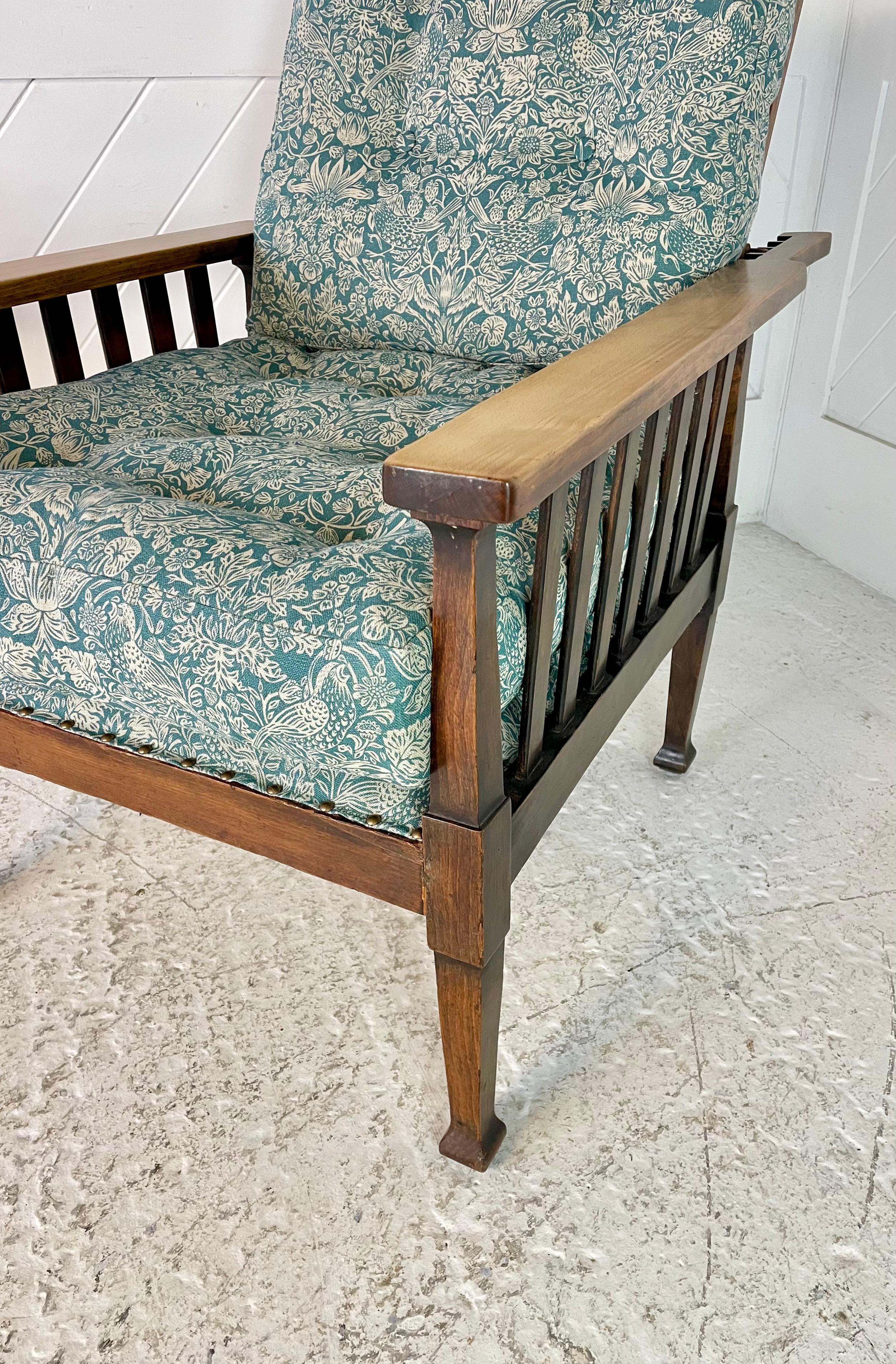 Arts & Crafts oak adjustable armchair

With slatted sides and paddle arms

Tapering legs with mushroom shaped feet

Re-uphlostered in Morris & Co linen fabric

Circa 1900

Height 98cm. Width 70cm. Depth 95cm Seat Height 46cm