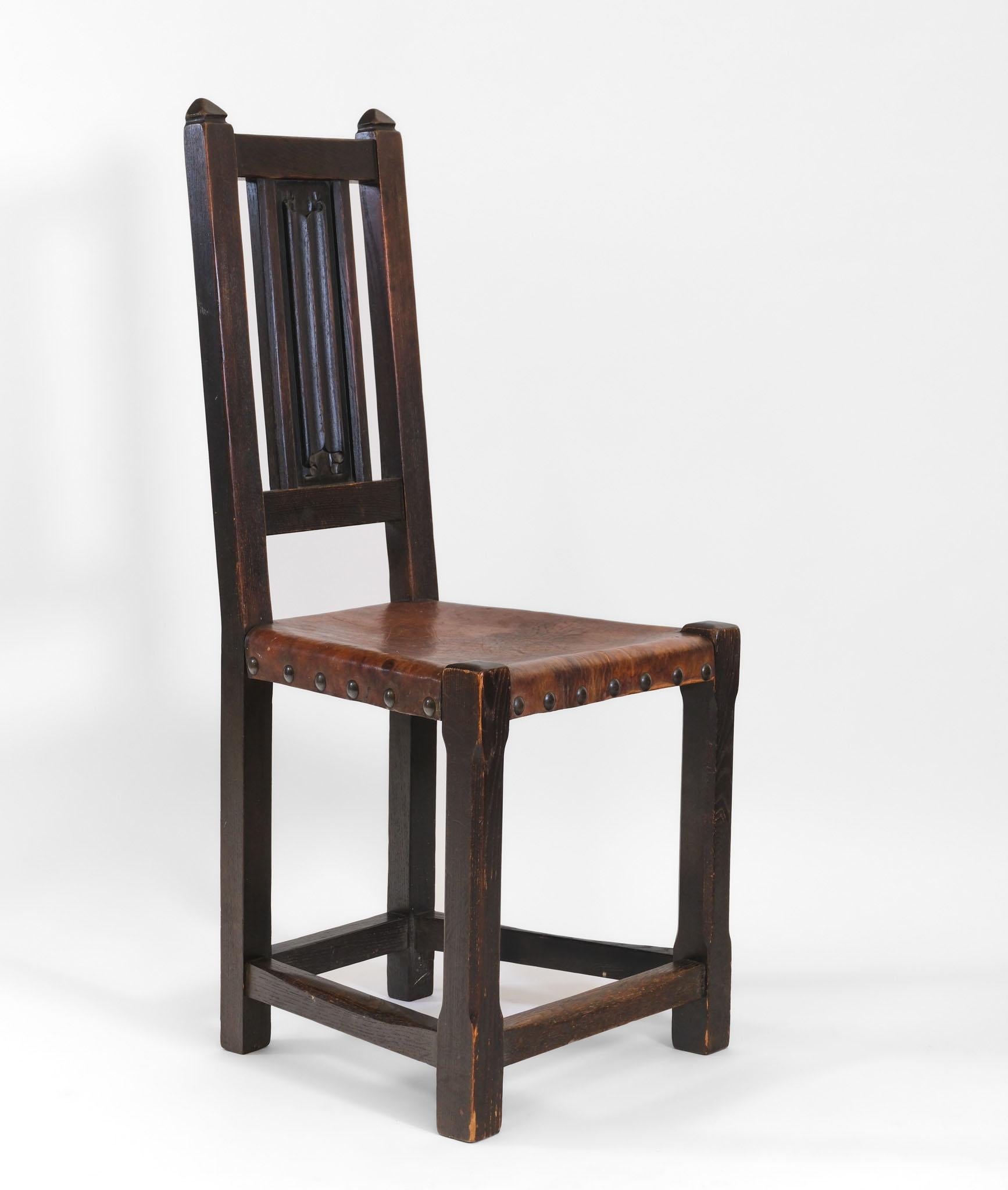 Arts & Crafts movement oak & leather arrowhead side chair with single linen fold central carved splat. Circa 1905.

Probably from a variant of the Liberty & Co Culloden range.

The chair is in original untouched condition, the leather seat being of