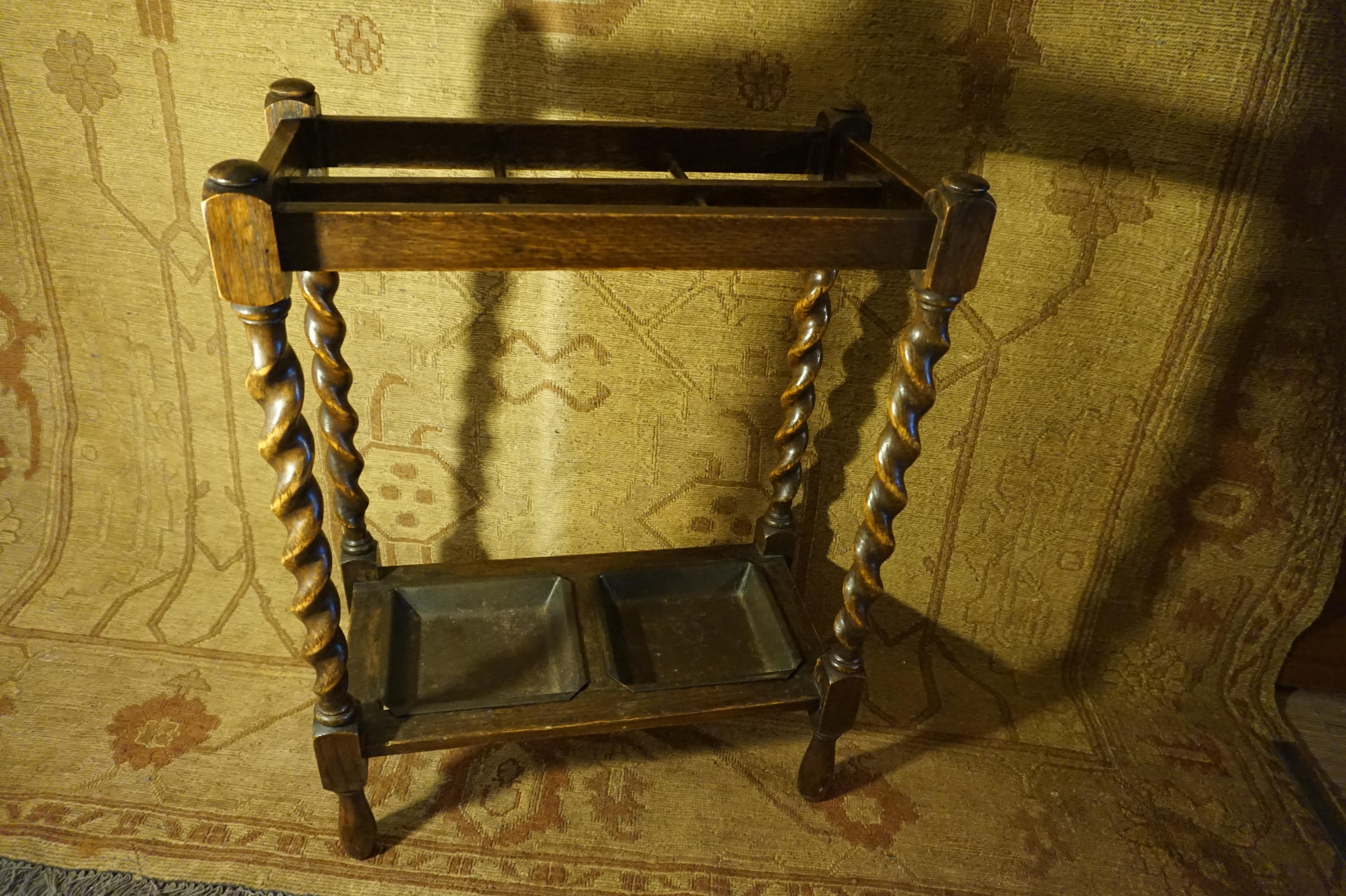 Circa 1900-1910

Warm oak patina hand made barley twist cane stand with simple lines, six sectionals and original metal drip pans. Compact size and elegant form highlight this quaint Arts & Crafts piece.