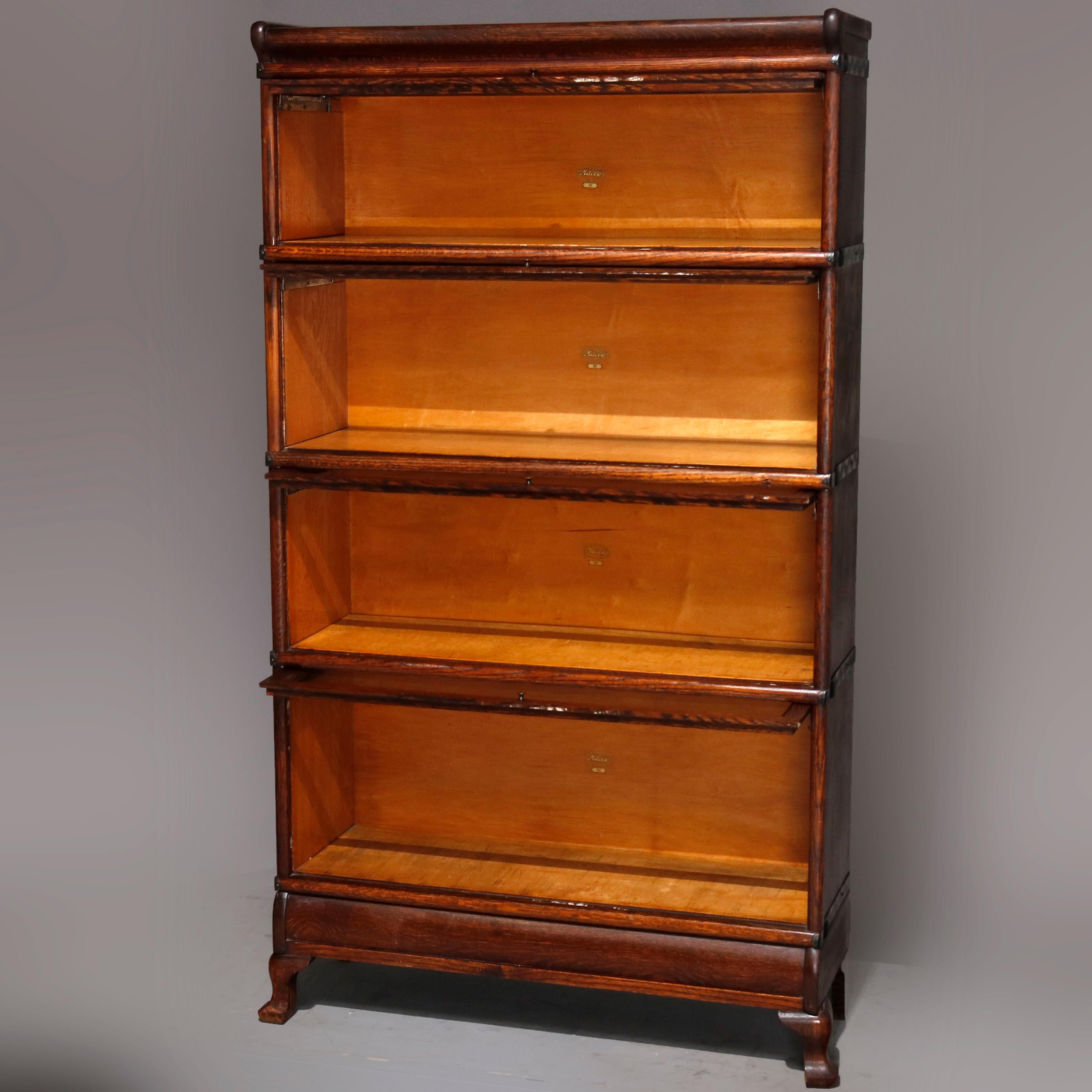 An antique Arts & Crafts barrister bookcase by Macey offers quarter sawn oak case having four sections with glass pull-out doors, original Macey label as photographed, circa 1910

Measures - 61