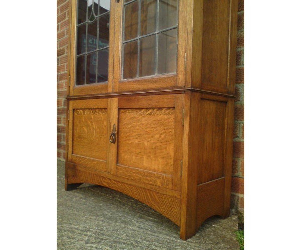 English Arts & Crafts Oak Bookcase with Stylized Floral Stain Glass and a Cupboard below