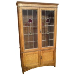 Arts & Crafts Oak Bookcase with Stylized Floral Stain Glass and a Cupboard below