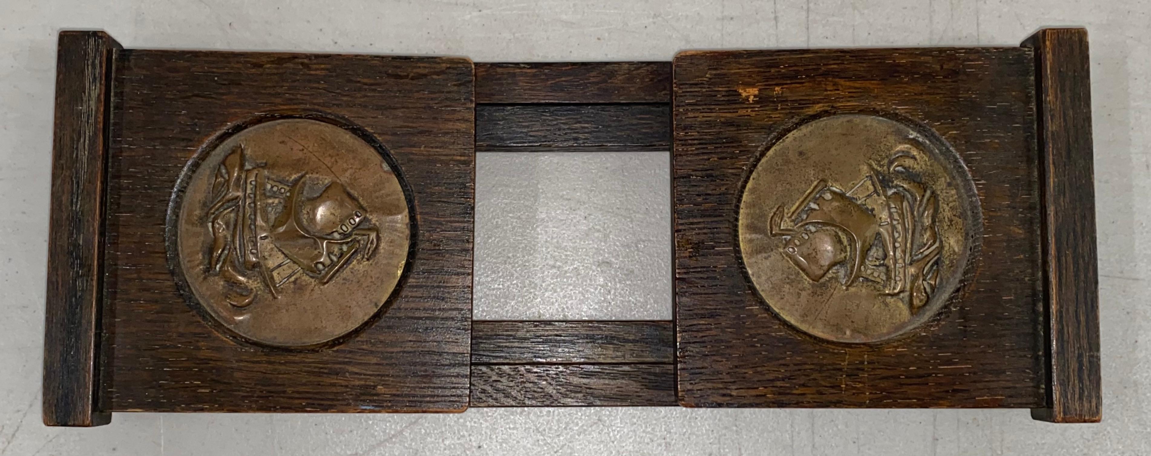 Arts & Crafts oak & brass folding / expanding book holder, C.1920s.

Hand crafted book holder with brass nautical tall ship medallions at each end

The book holder is foldable and it expands as your collection grows

Measures: 17.5