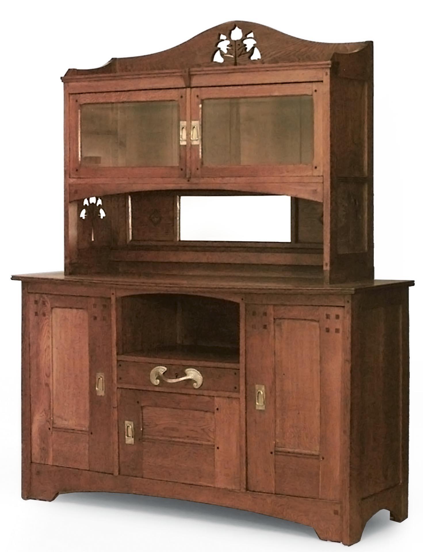French Arts and Crafts oak cupboard cabinet with stylized bronze handles and floral cut outs on sides and pediment (Attributed to: Leon Jallot)
