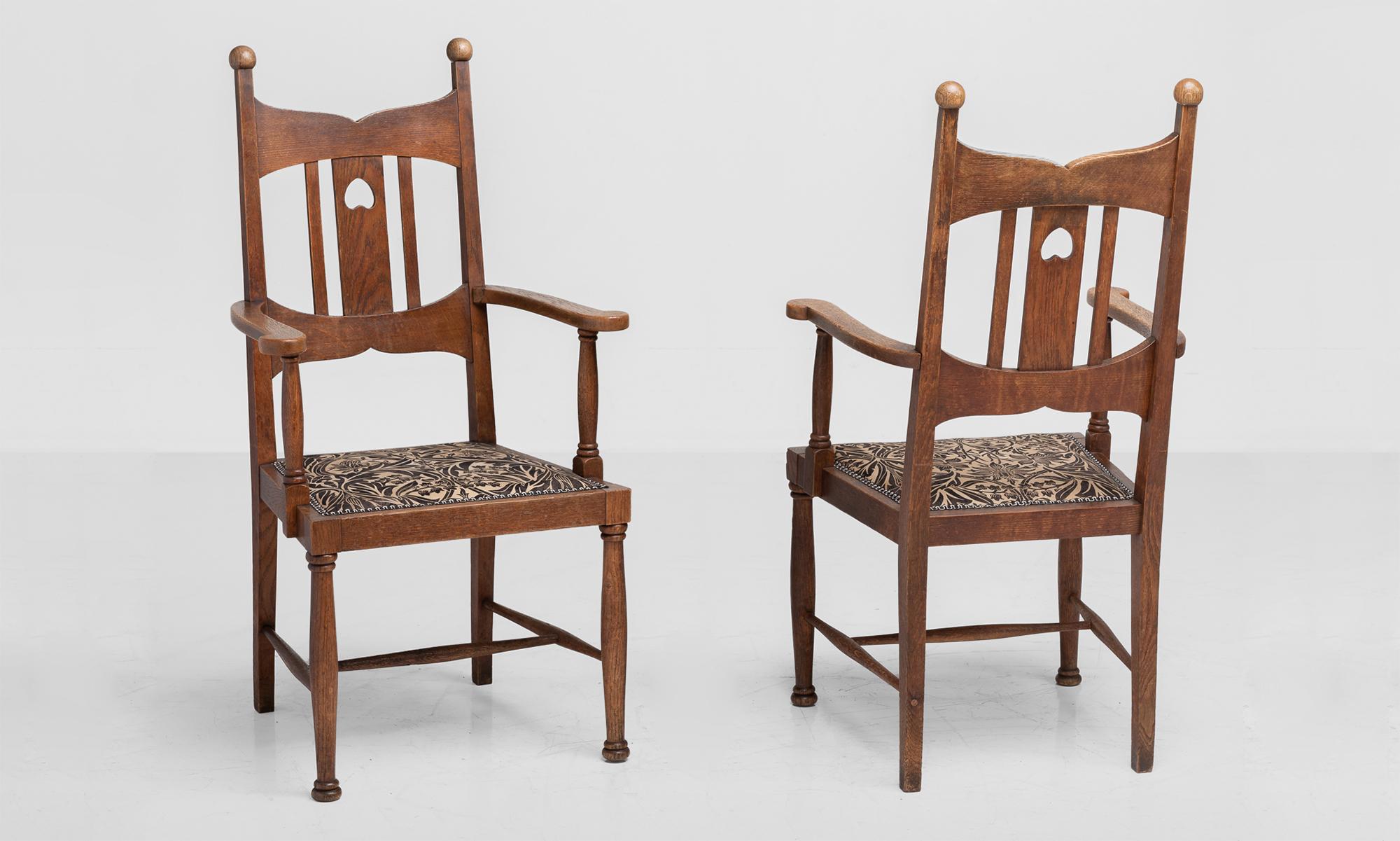 Arts & Crafts oak dining armchairs, England, circa 1900.

Highback oak dining armchairs in the manner of Liberty & Co. with upholstered seat in the style of William Morris.

Measures: 24