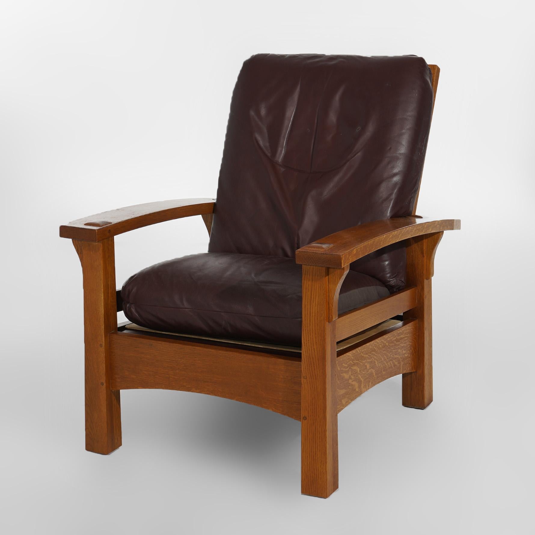 ***Ask About Discounted In-House Shipping***
An Arts and Crafts Gustav Stickley Morris style arm chair offers oak construction with slat back, bow arms, reverse tapered legs and upholstered back and seat, maker label as photographed, 20th