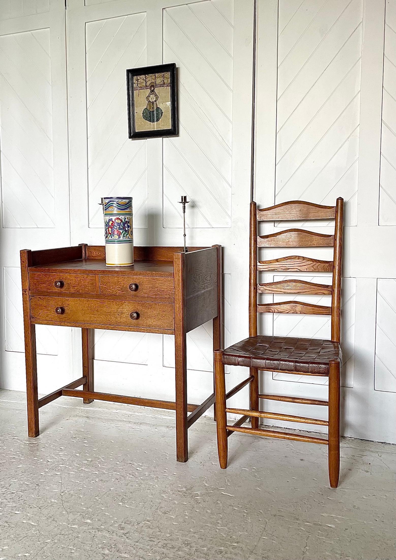 Arts & Crafts 3 drawer oak hall table 

Brass candle holders attached to raised back rail, inset circular leather panel  

Designed by Ambrose Heal

Circa 1910

Height 85cm.  Width78cm.  Depth 49cm
