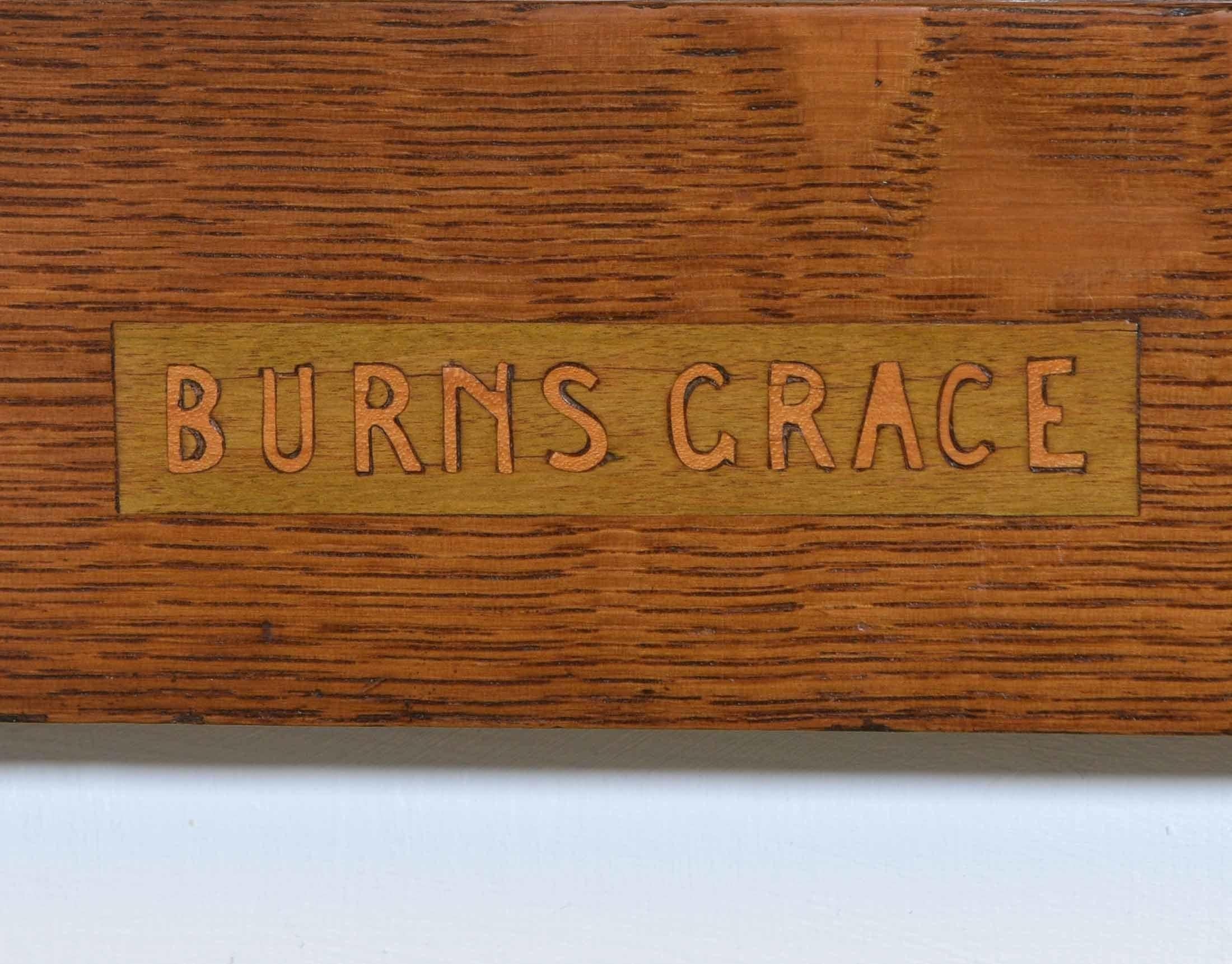 An Arts & Crafts oak wall mirror with Robert Burns incised motto and inlaid decoration. Circa 1910.

Burns Grace
'Some hae meat and canna eat
And some wad eat that want it
But we hae meat and we can eat
And sae the Lord be thankit.'

The bevelled