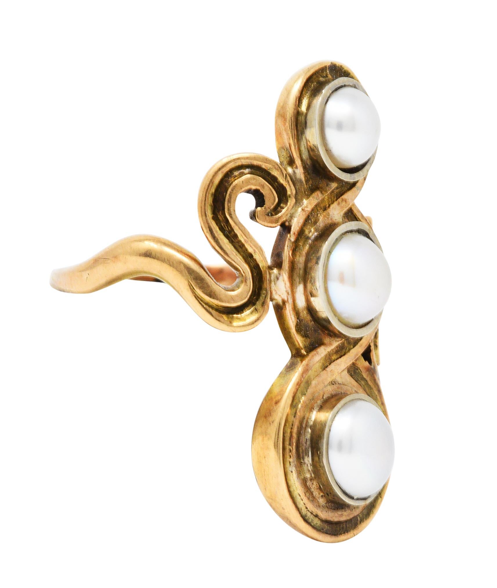 Full finger ring centers three button pearls - very well matched

Measuring from 4.5 mm to 5.5 mm with white to cream color and strong iridescence

Each is bezel set then surrounded by a scrolling figure eight design

Stamped 14K for 14 karat