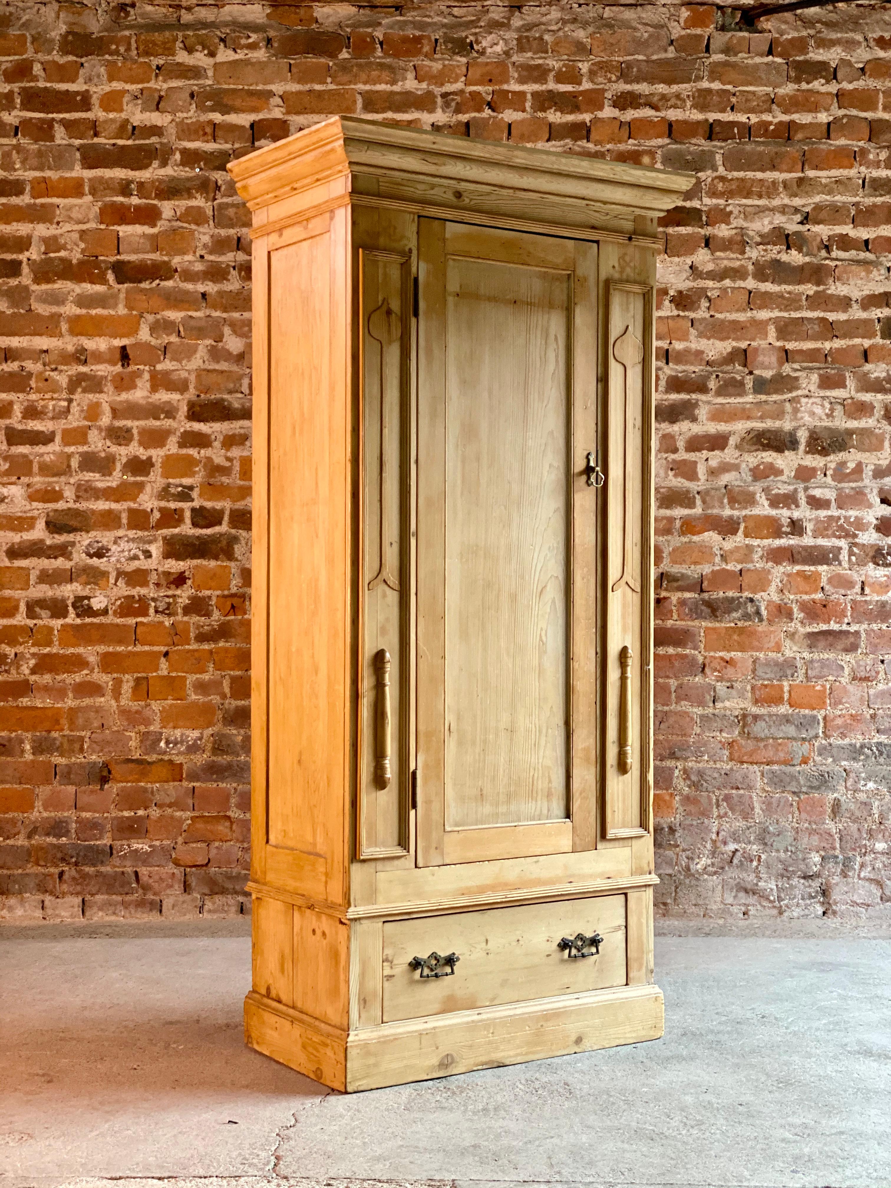 Fabulous Arts & Crafts pine single door wardrobe circa 1910, t early 20th century single door wardrobe, the moulded corniced upper section above a single paneled door flanked by Arts & Crafts decoration, hanging rail and hooks within, the base