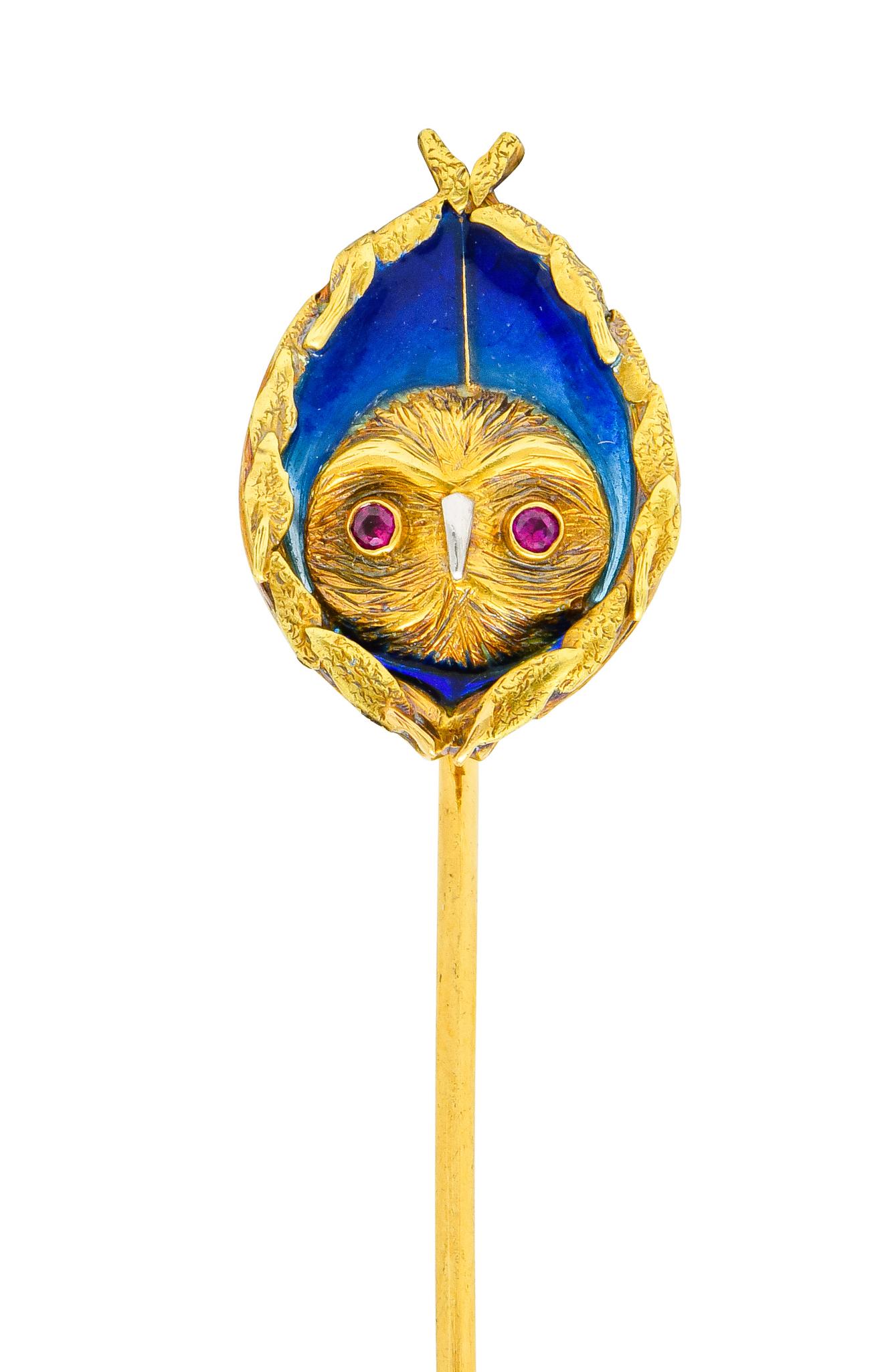 Centering a highly textured owl face accented by round cut ruby eyes and a shining platinum beak

Surrounded by serene plique-á-jour royal blue enamel, in excellent condition

Completed by wreath border comprised of stylized foliate

Tested as 18