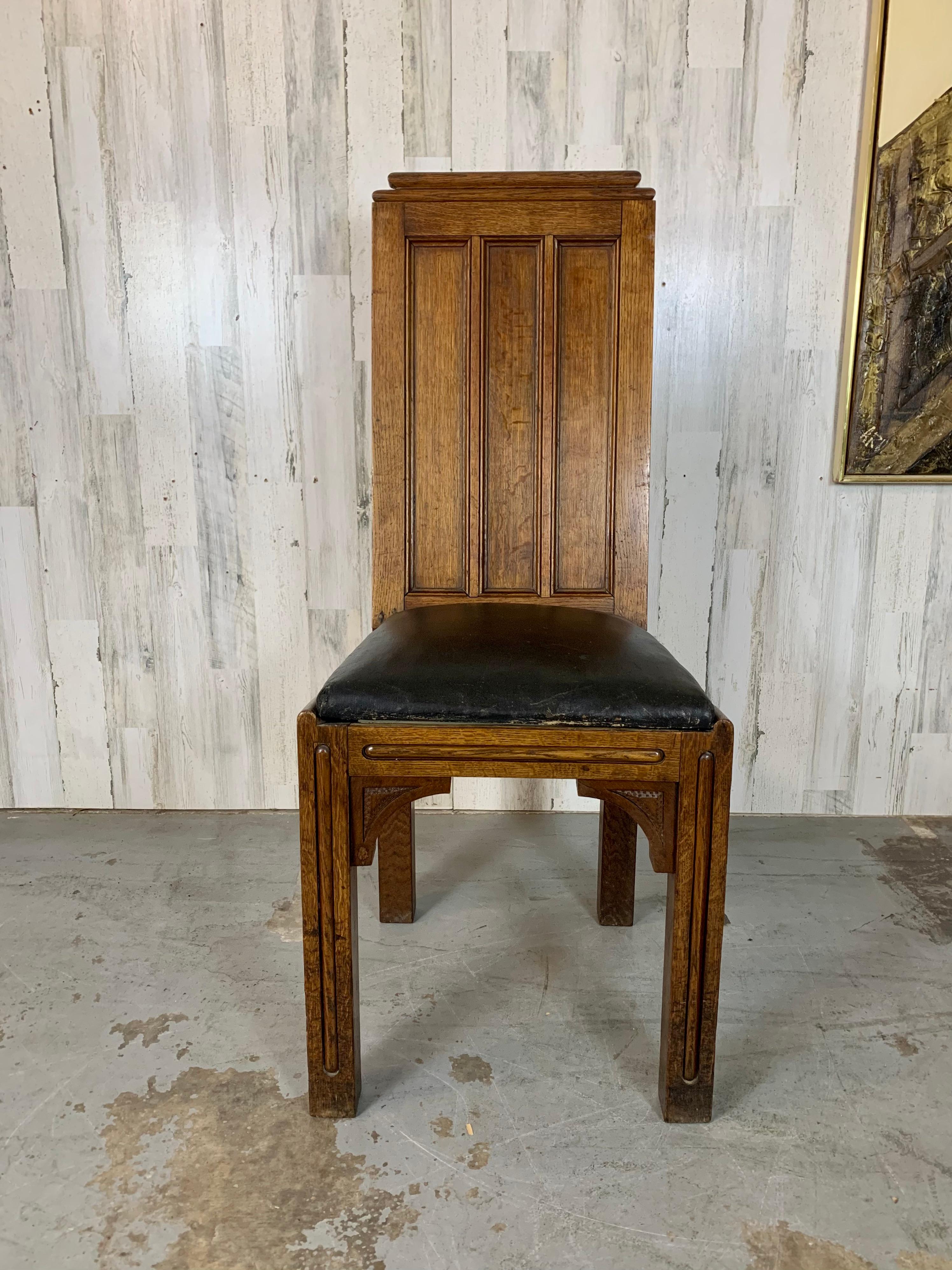 Substantial side chair made of quarter sawn oak with original upholstery. From the Arts & Crafts era with Gothic accents makes this chair a real show piece for any location in your home.  