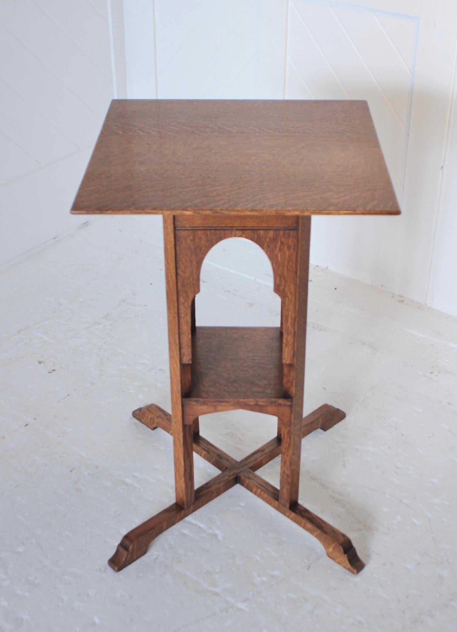 An unusual Arts & Crafts quarter-sawn oak side table. This table has been influenced by the Moresque style with arched and beaded panels. This design looks as if it should be by Liberty & Co but it also has elements which relate to some Austrian