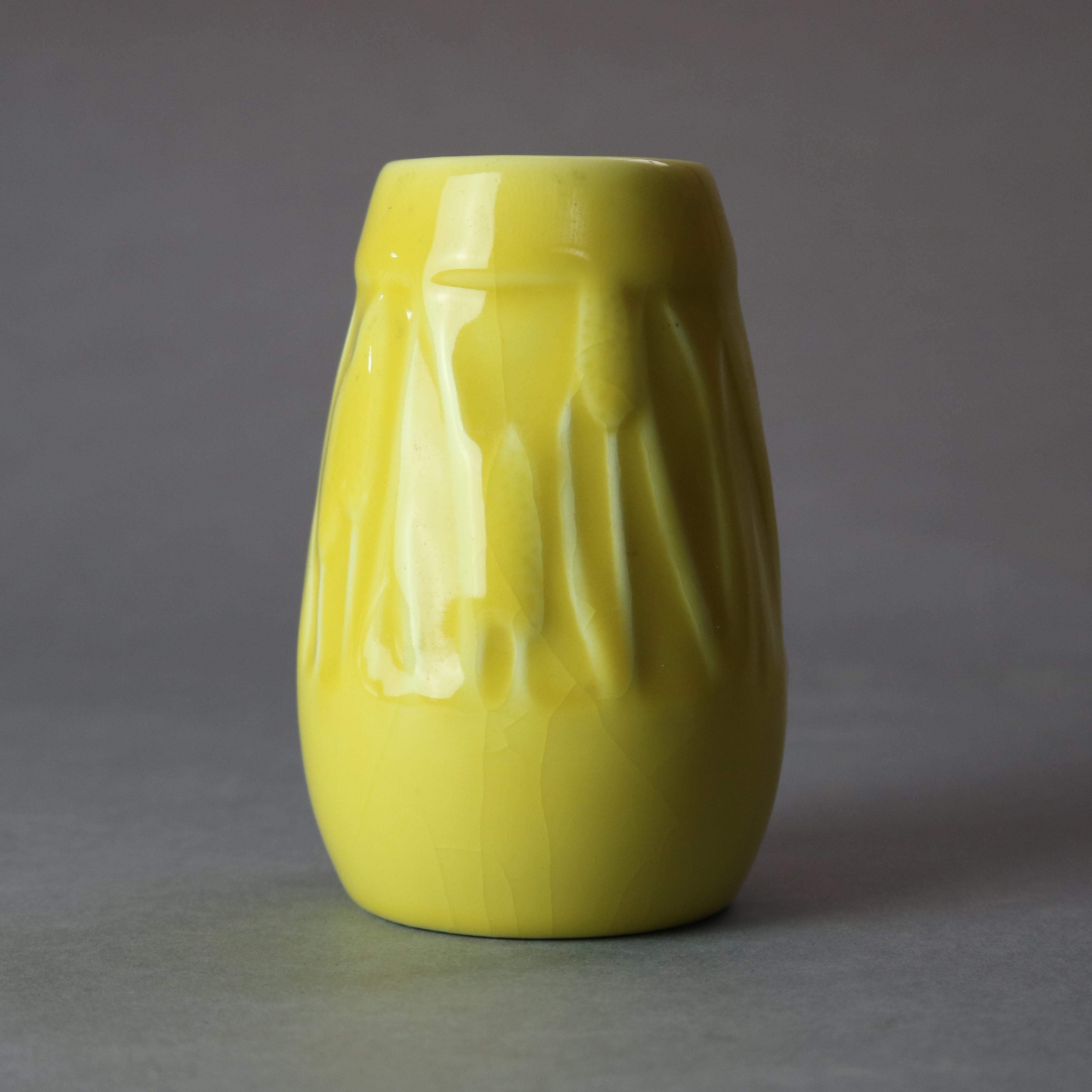 An Arts & Crafts vase by Rookwood offers art pottery construction in yellow high gloss glaze with a wide band of incised stylized cattails, signed on base as photographed, circa 1930

Measures: 5