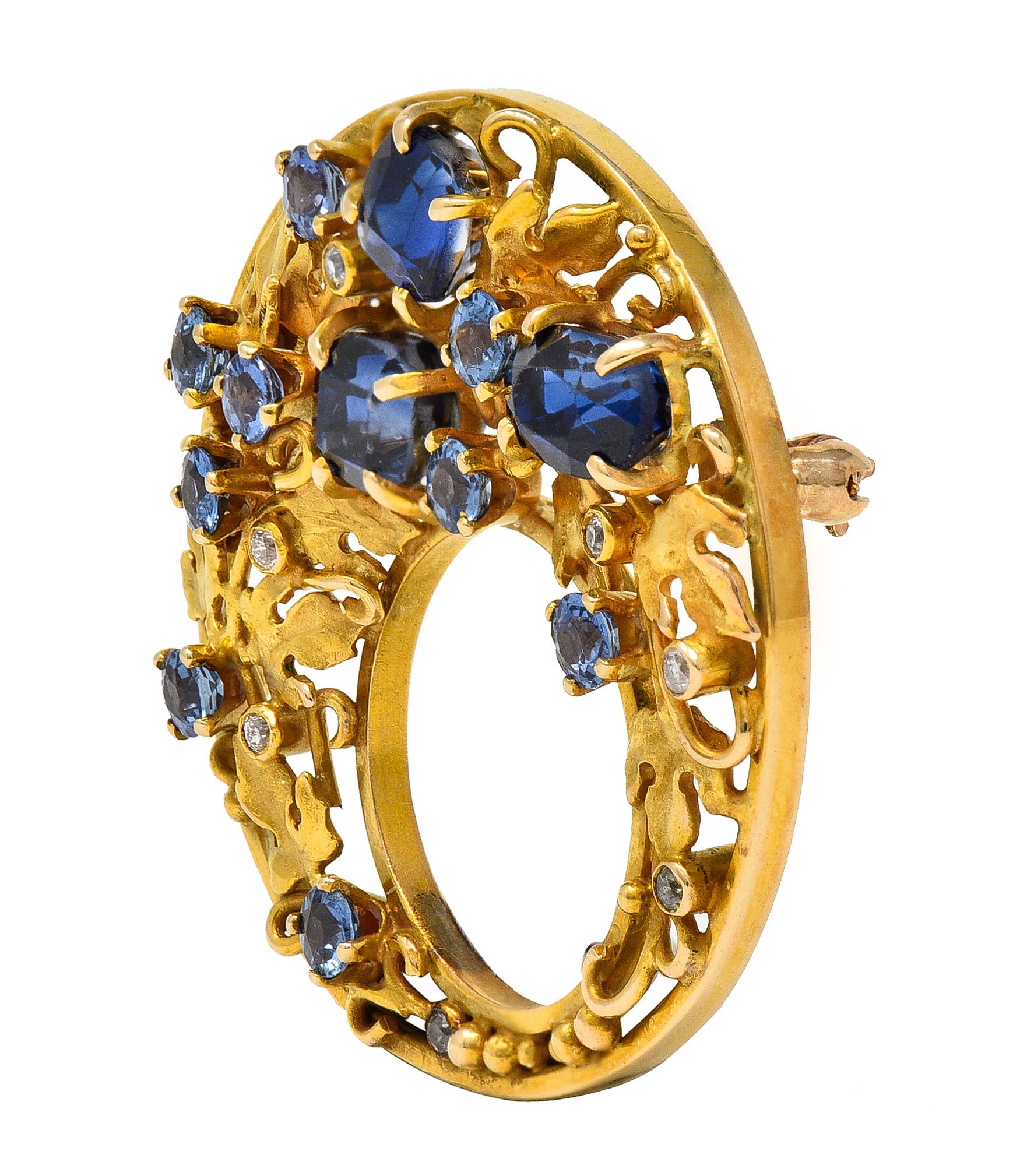 Designed as a circular disk form comprised of pierced creeping ivy motif 
With curling vines, leaves, and gold beading throughout
Prong set throughout with round and cushion cut sapphires
Weighing approximately 2.73 carats total 
Transparent light