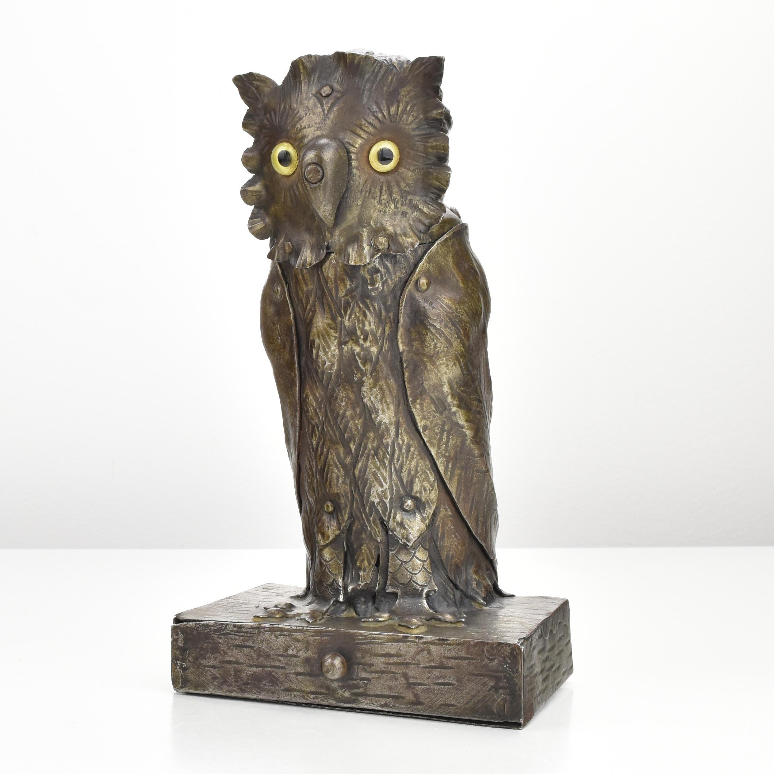 Fantastic hand-forged Arts & Crafts figural Inkwell in shape of an owl, believed to be made by Goberg ~ 1900. The owl is made of forged iron with a lovely patina and bears yellow glass eyes. The head is hinged to get access to the inkwell and the